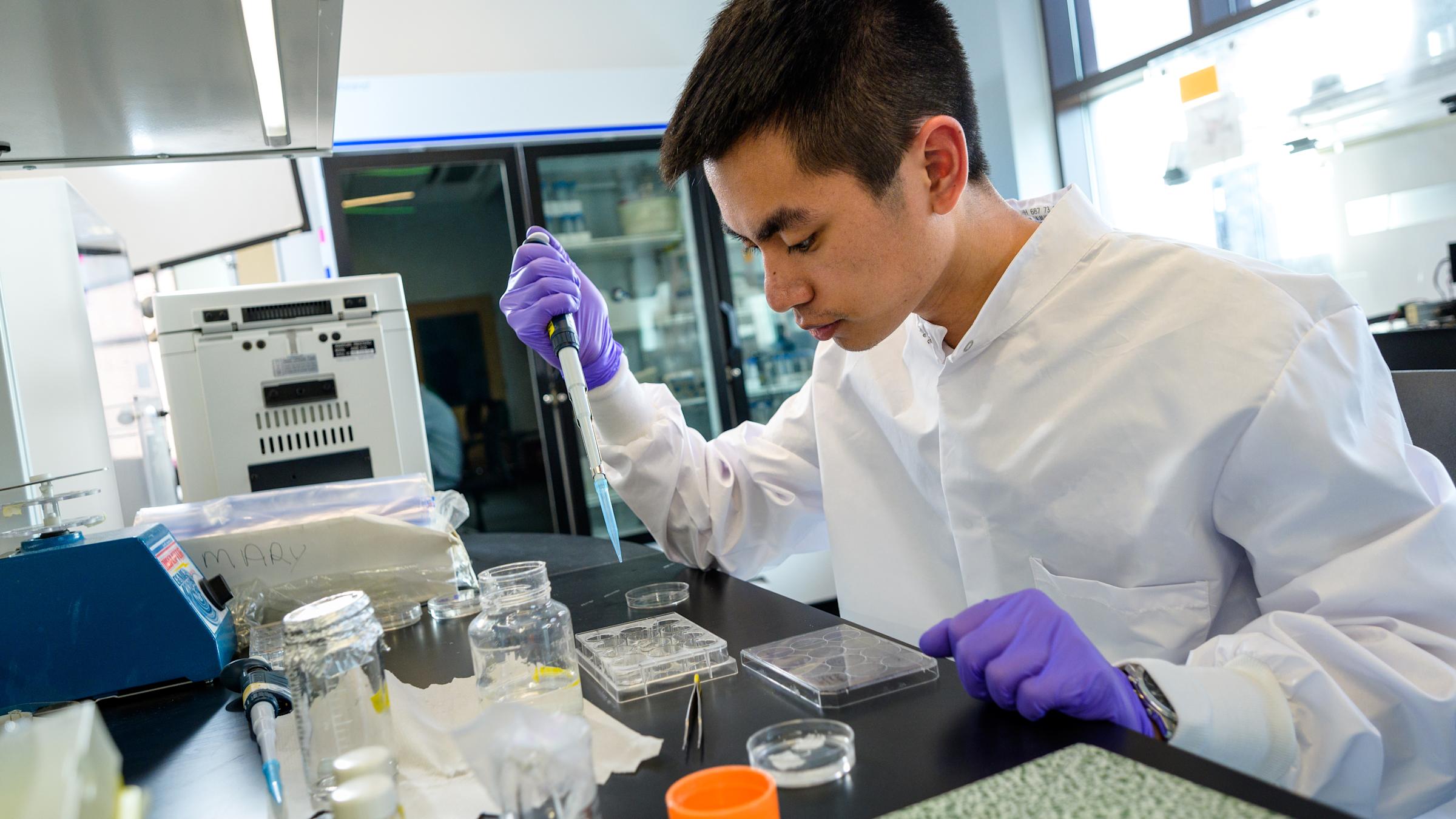 Student in lab with dropper