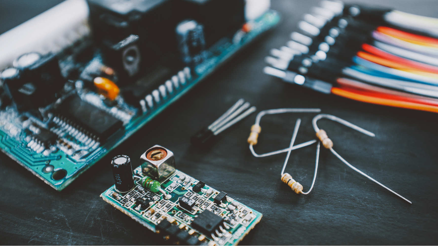 Close up of electrical components on a dark table.