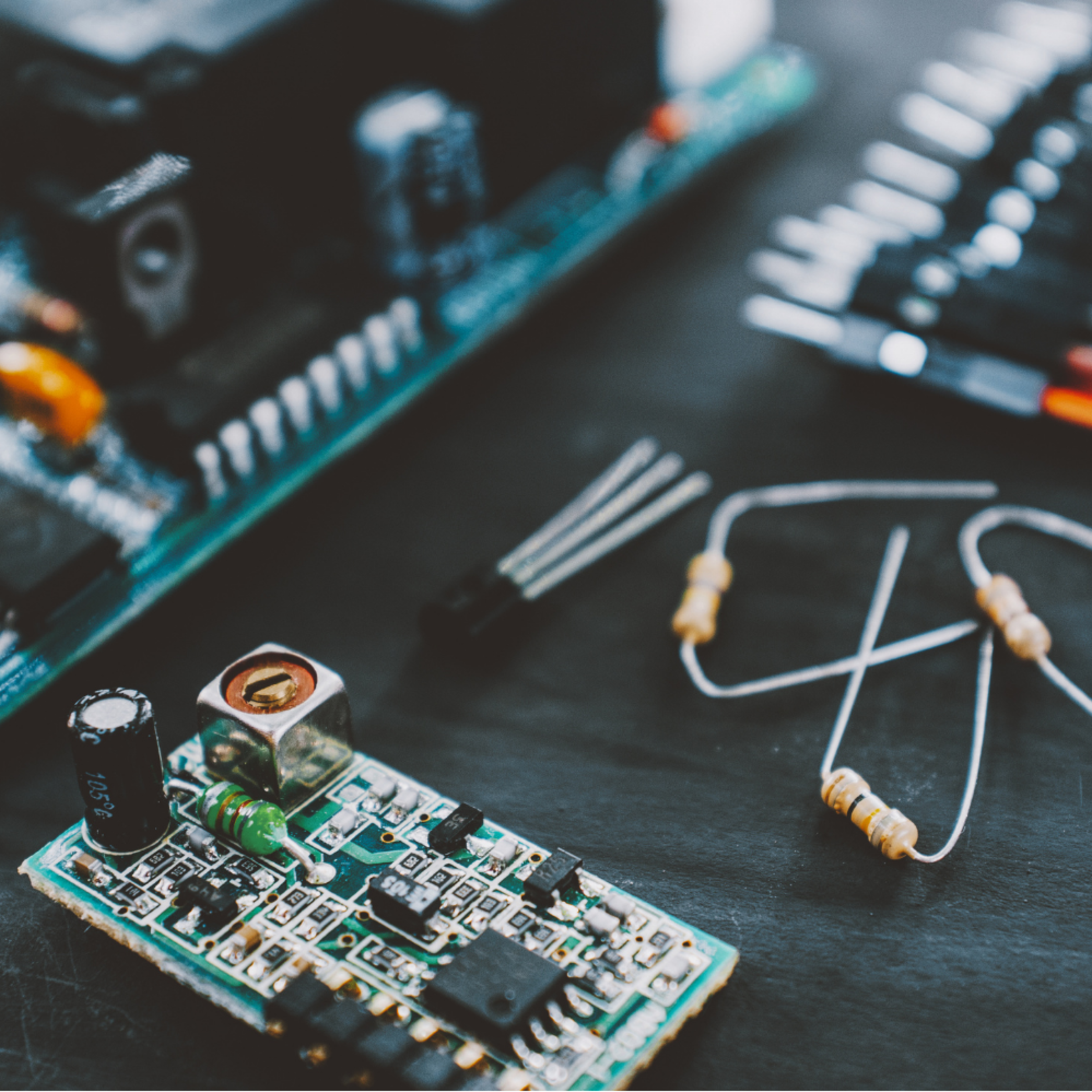 Close up of electrical components on a dark table.
