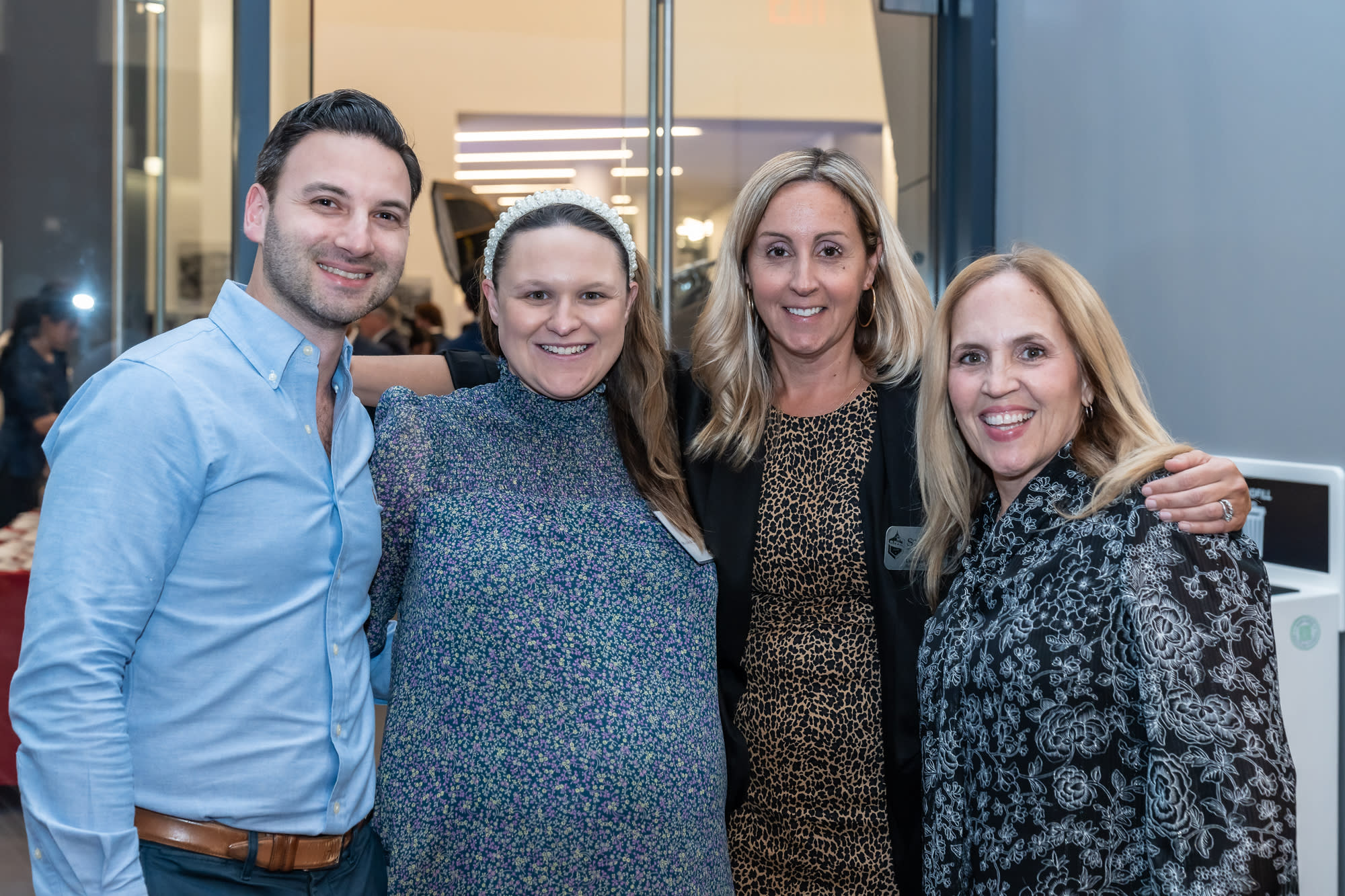 Four people pose for a group photo