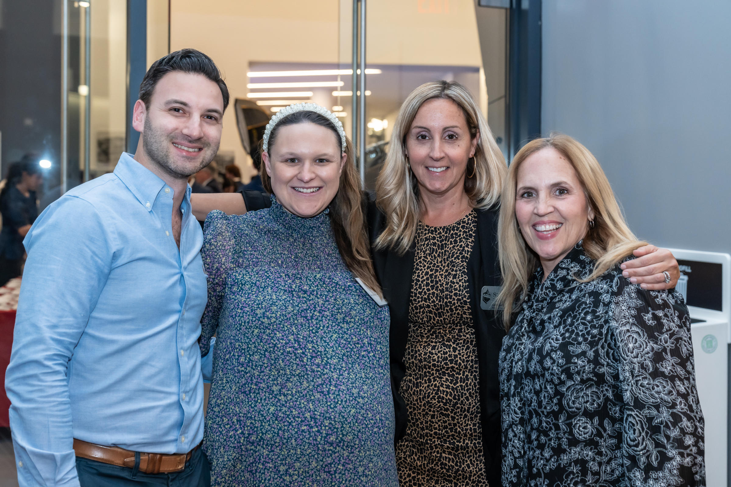 Four people pose for a group photo