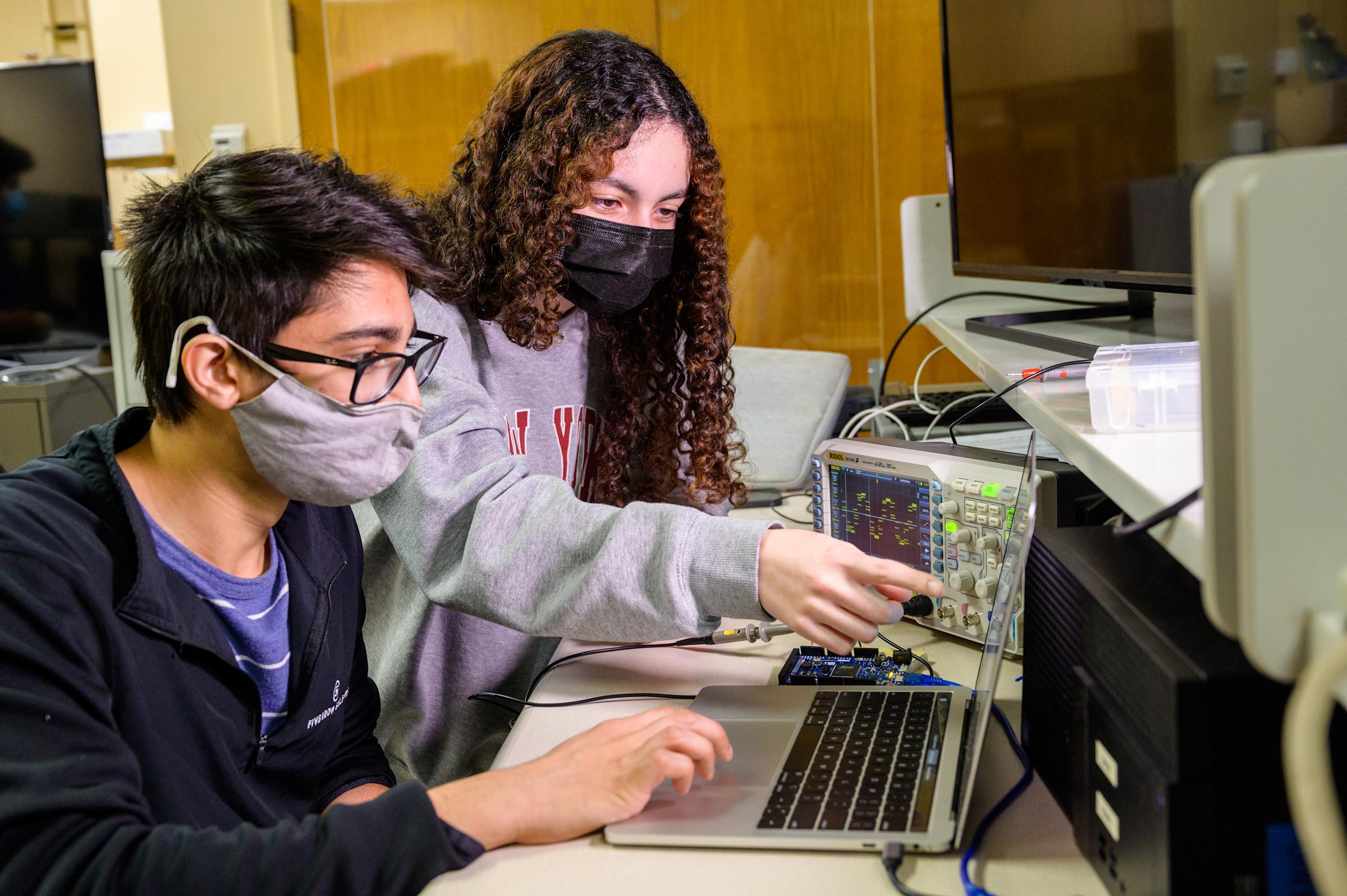 Students collaborate on electrical project.