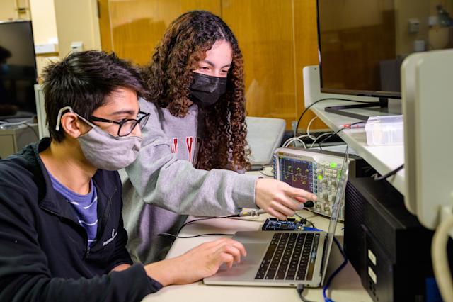 Students collaborate on electrical project.