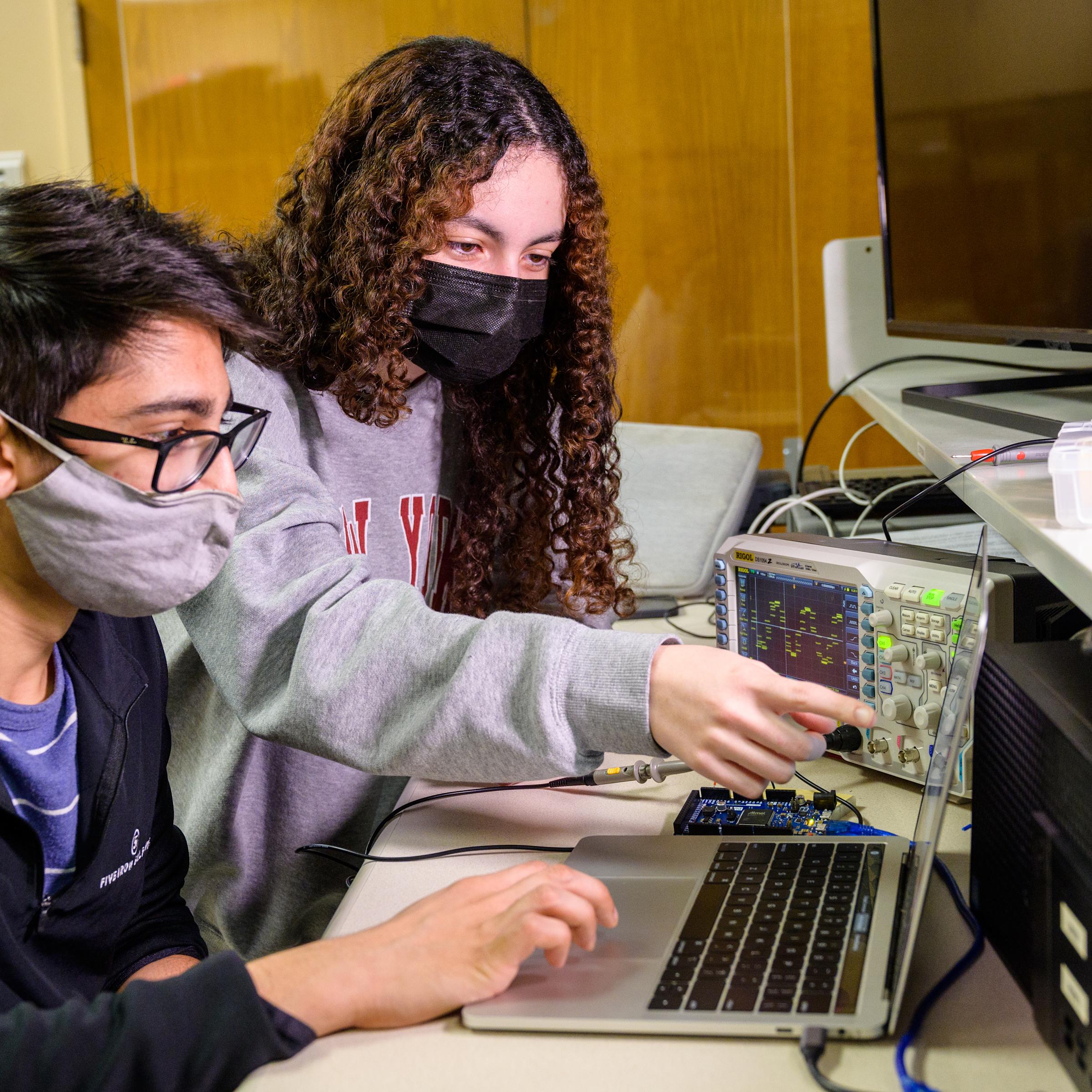 Students collaborate on electrical project.