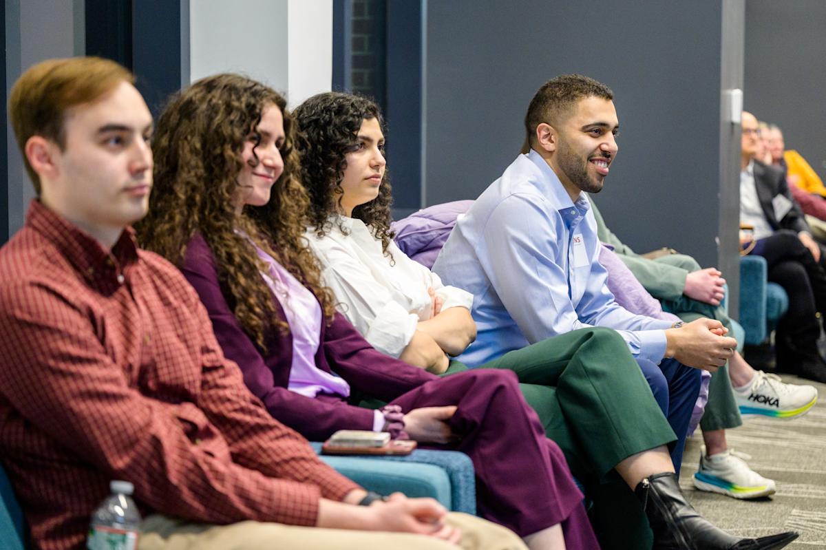 Four Stevens alumni sit and participate in a career networking event