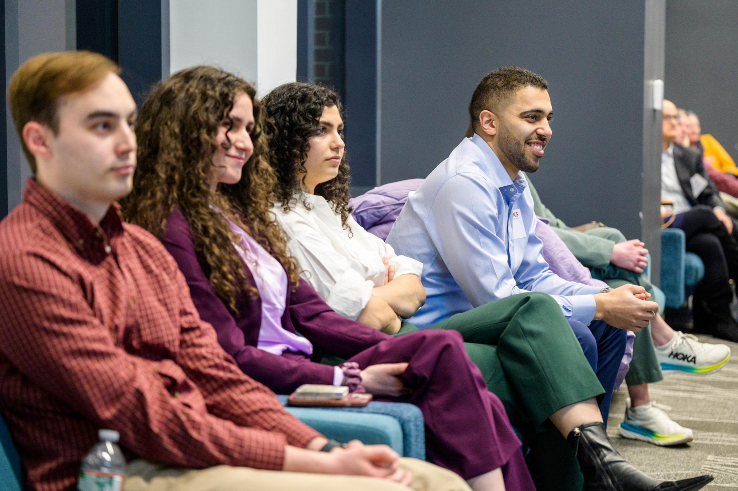 Four Stevens alumni sit and participate in a career networking event