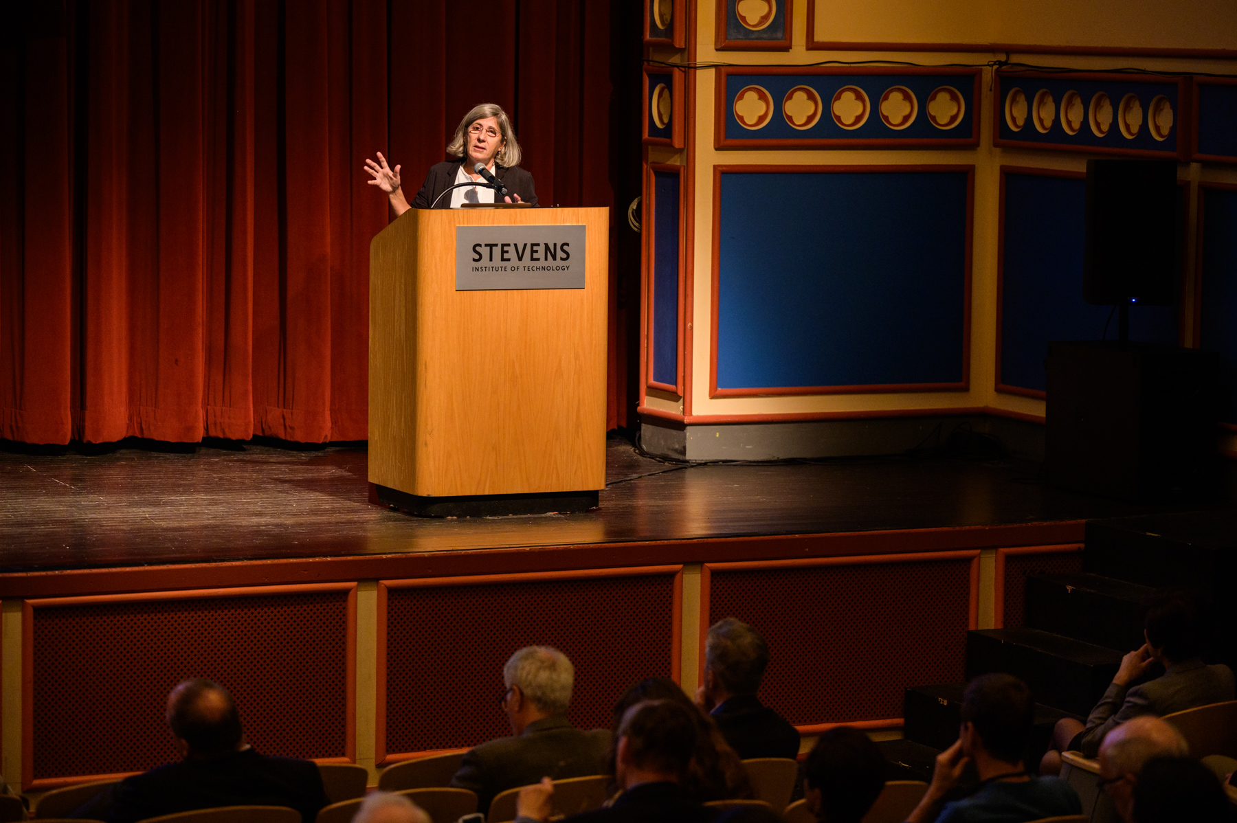 Manuela Veloso, Ph.D. Head of AI Research, JPMorgan Chase & Co. speaks from behind a podium on a stage.