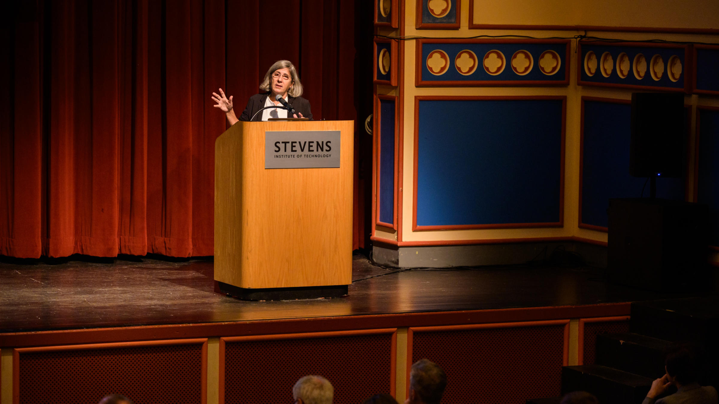 Manuela Veloso, Ph.D. Head of AI Research, JPMorgan Chase & Co. speaks from behind a podium on a stage.