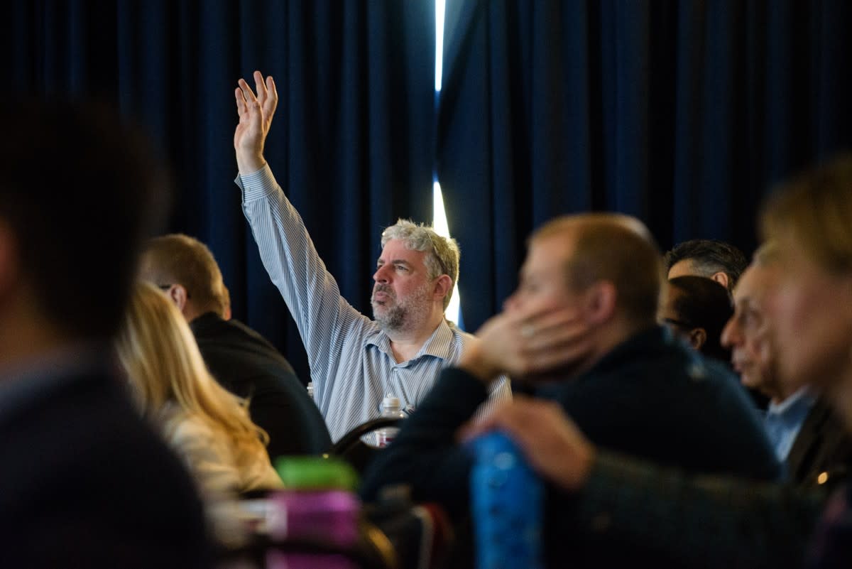 Man raises his hand
