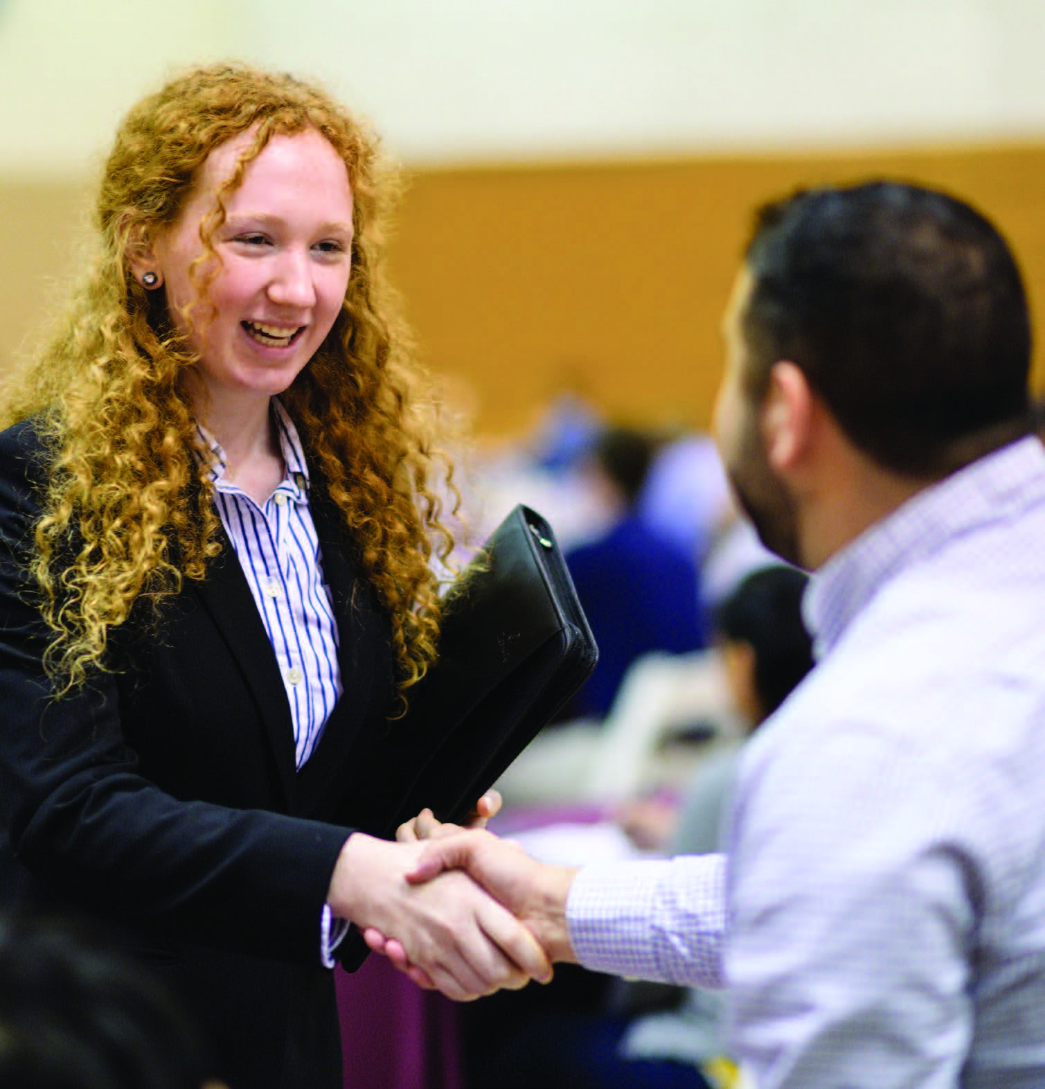 Stevens student shaking hands with a recruiter