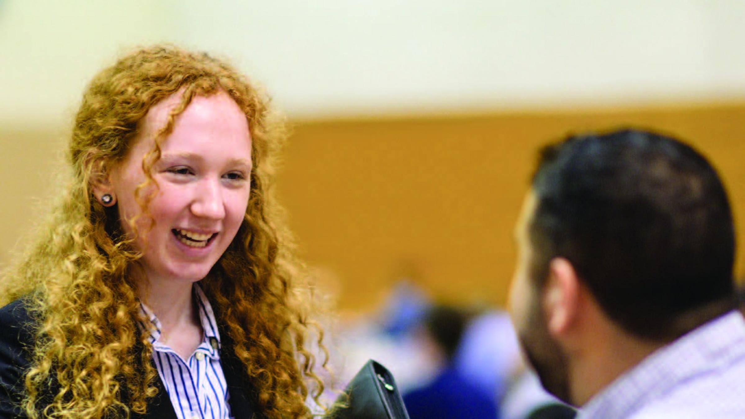 Stevens student shaking hands with a recruiter