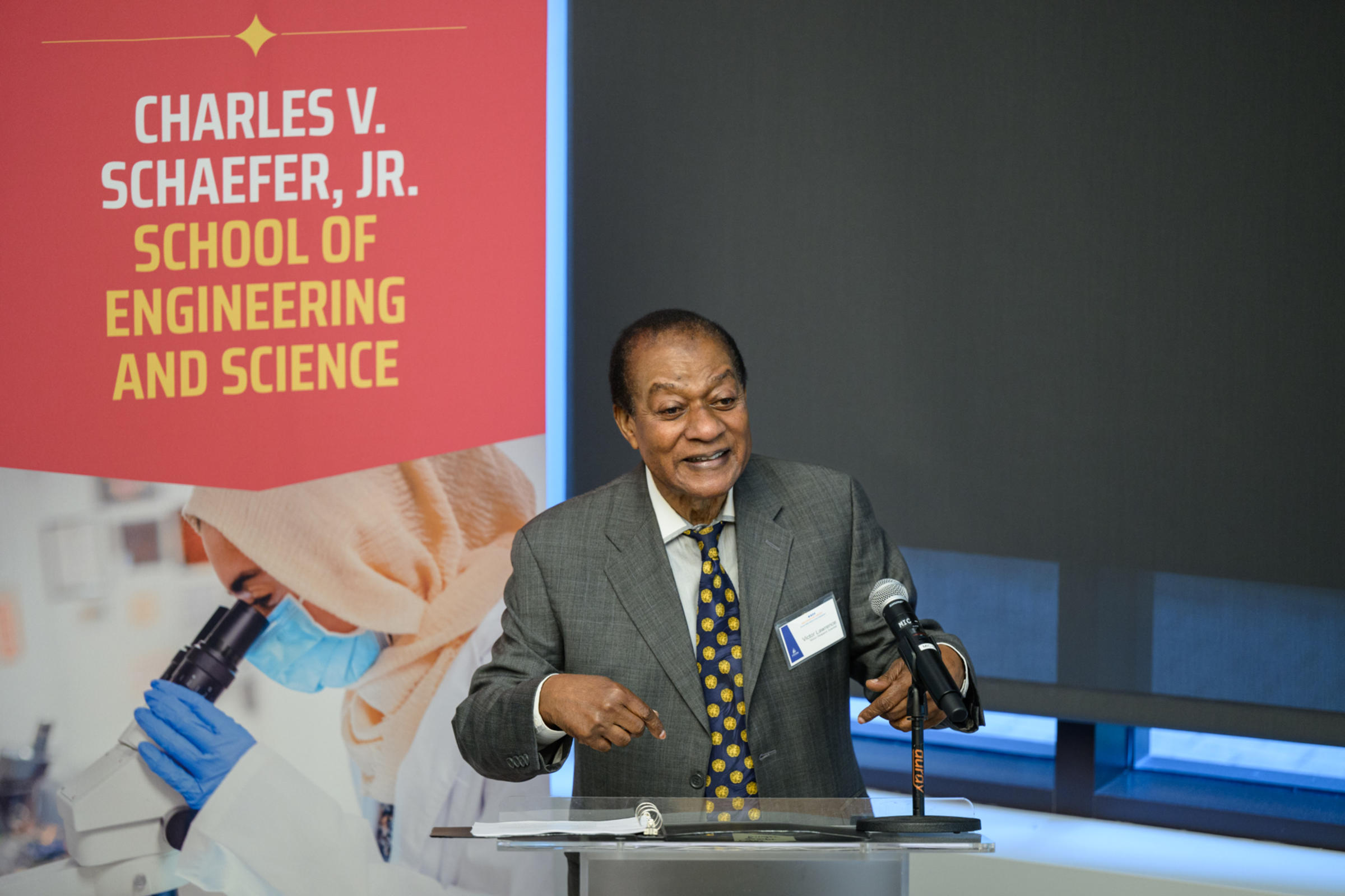 Victor Lawrence speaks from behind a podium.