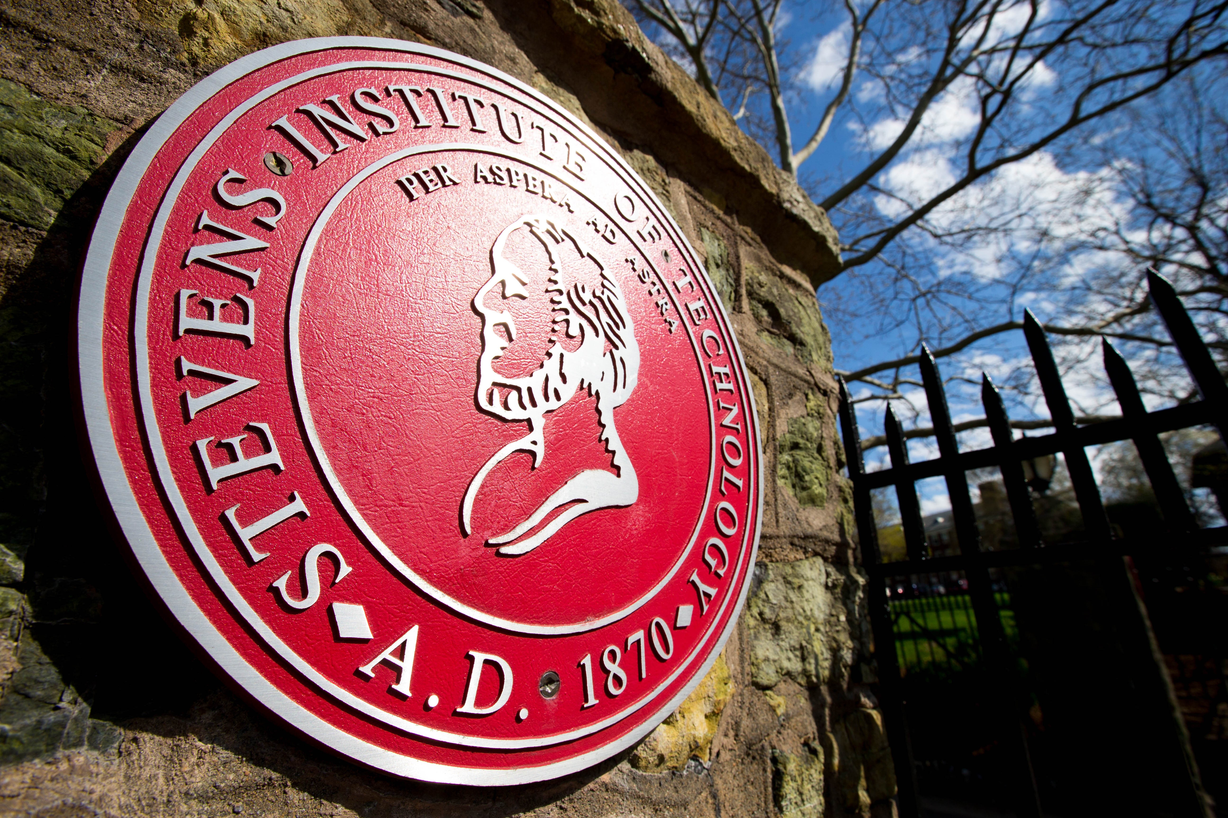 Stevens big, red, round seal. On seal, in rounded lettering, it says, Stevens Institute of Technology 1870 A.D. Per Apera ad Astera.
