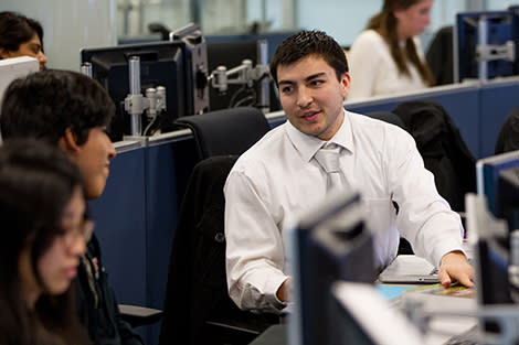 A student speaking behind a computer