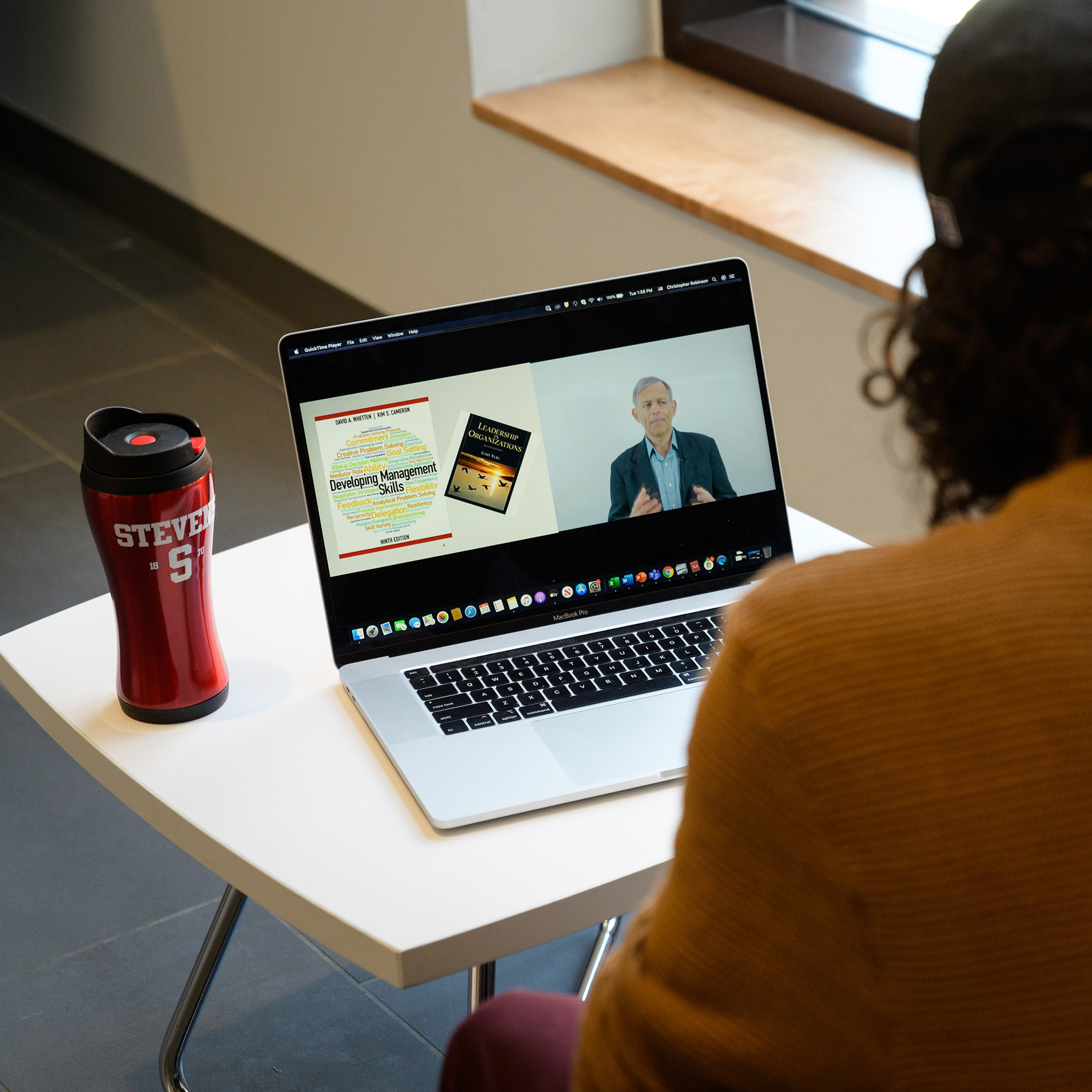 Student attending an online lecture on their laptop