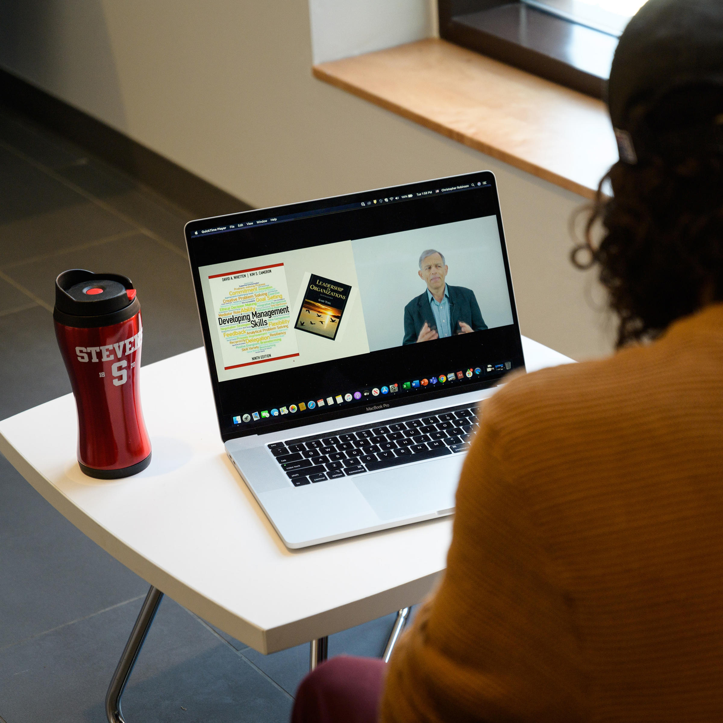 Student attending an online lecture on their laptop