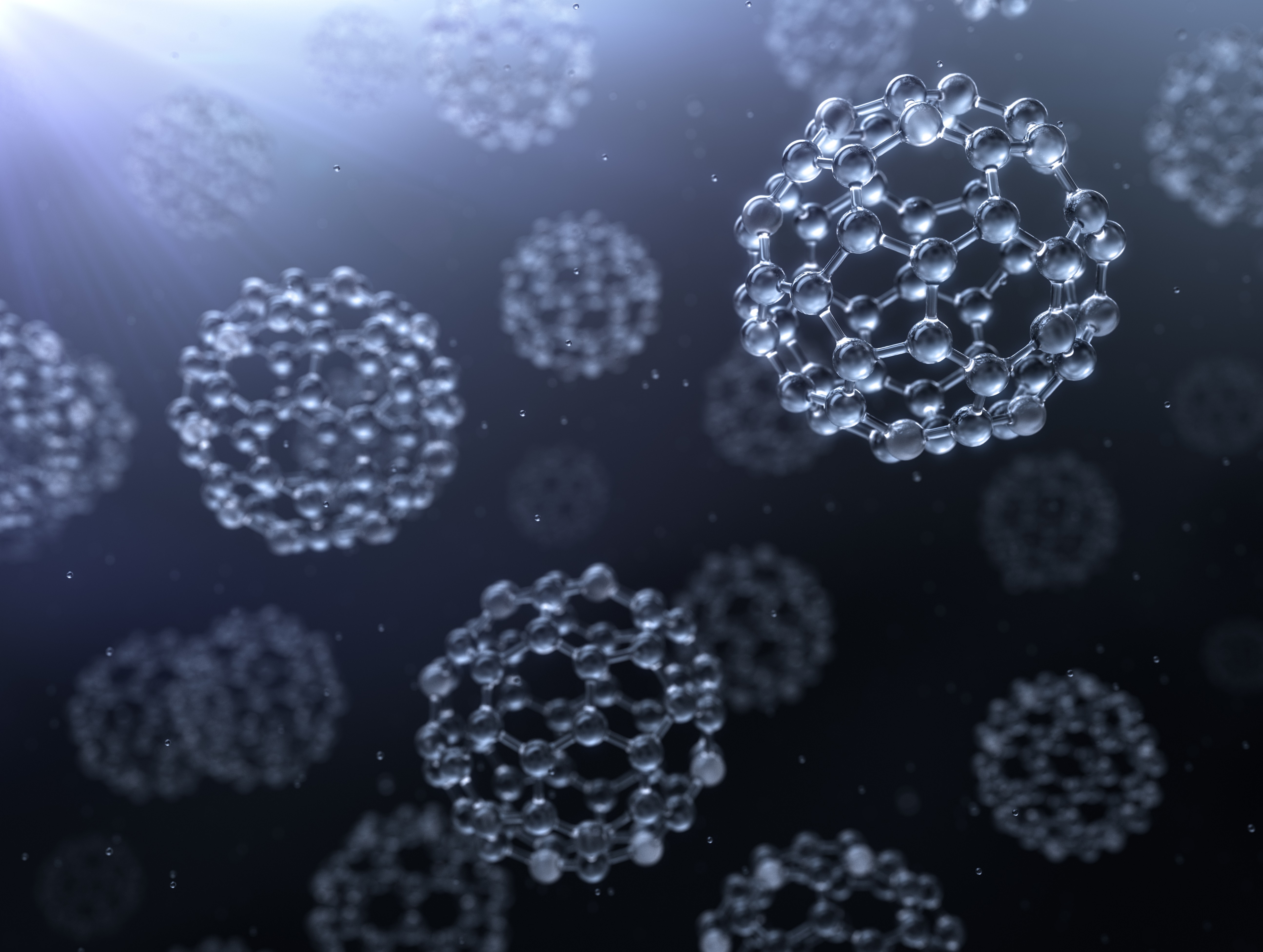 An illustration of nanoparticles, which look like molecular structures in the shapes of spheres.
