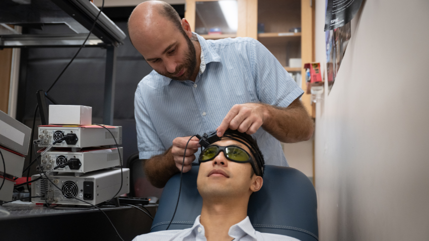 Simon Mahler with a test subject in his lab.