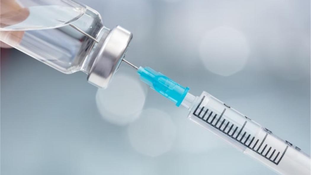 A photo of a vaccine being drawn with a syringe