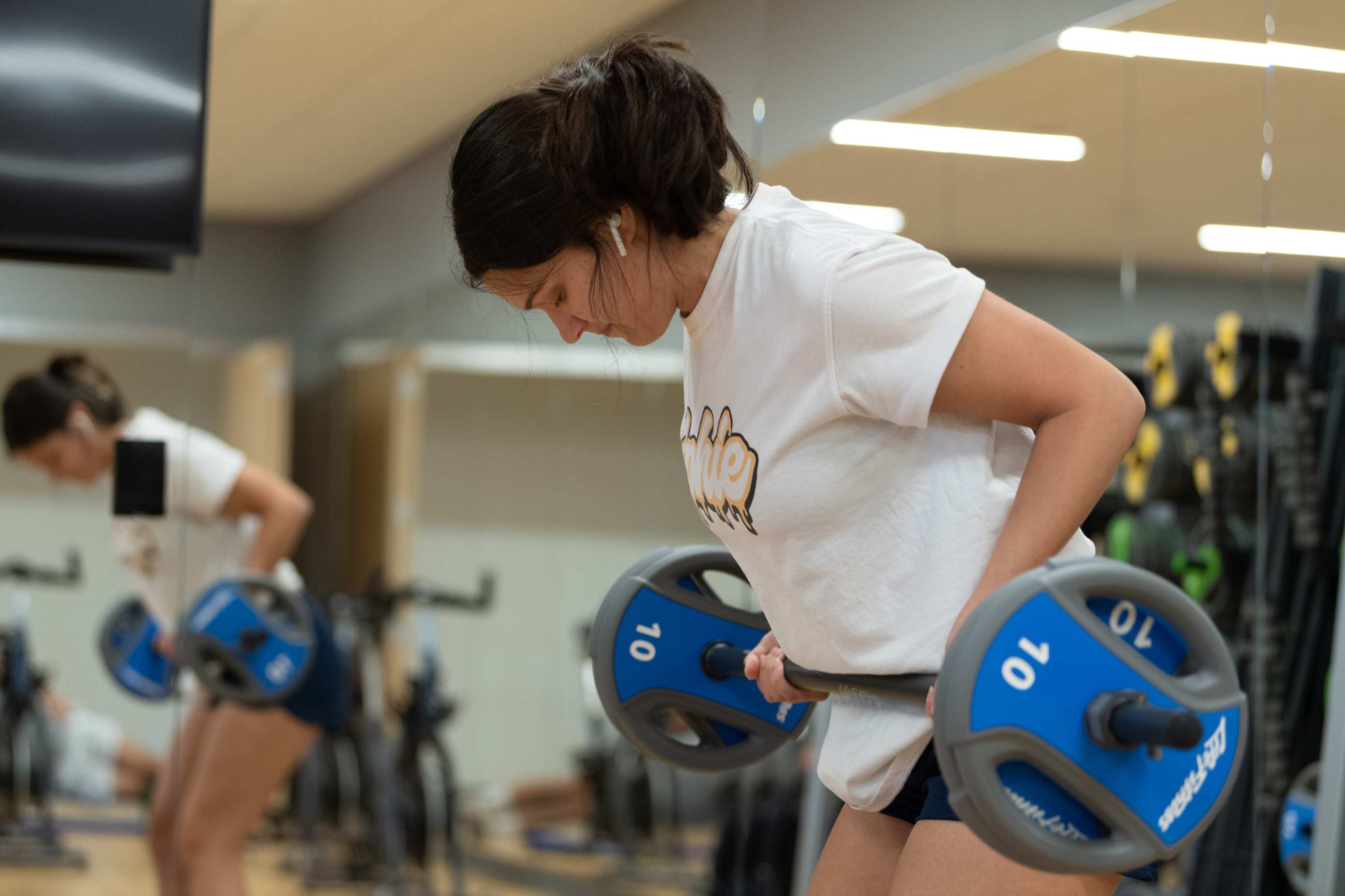 Student lifts weights in the UCC fitness center.