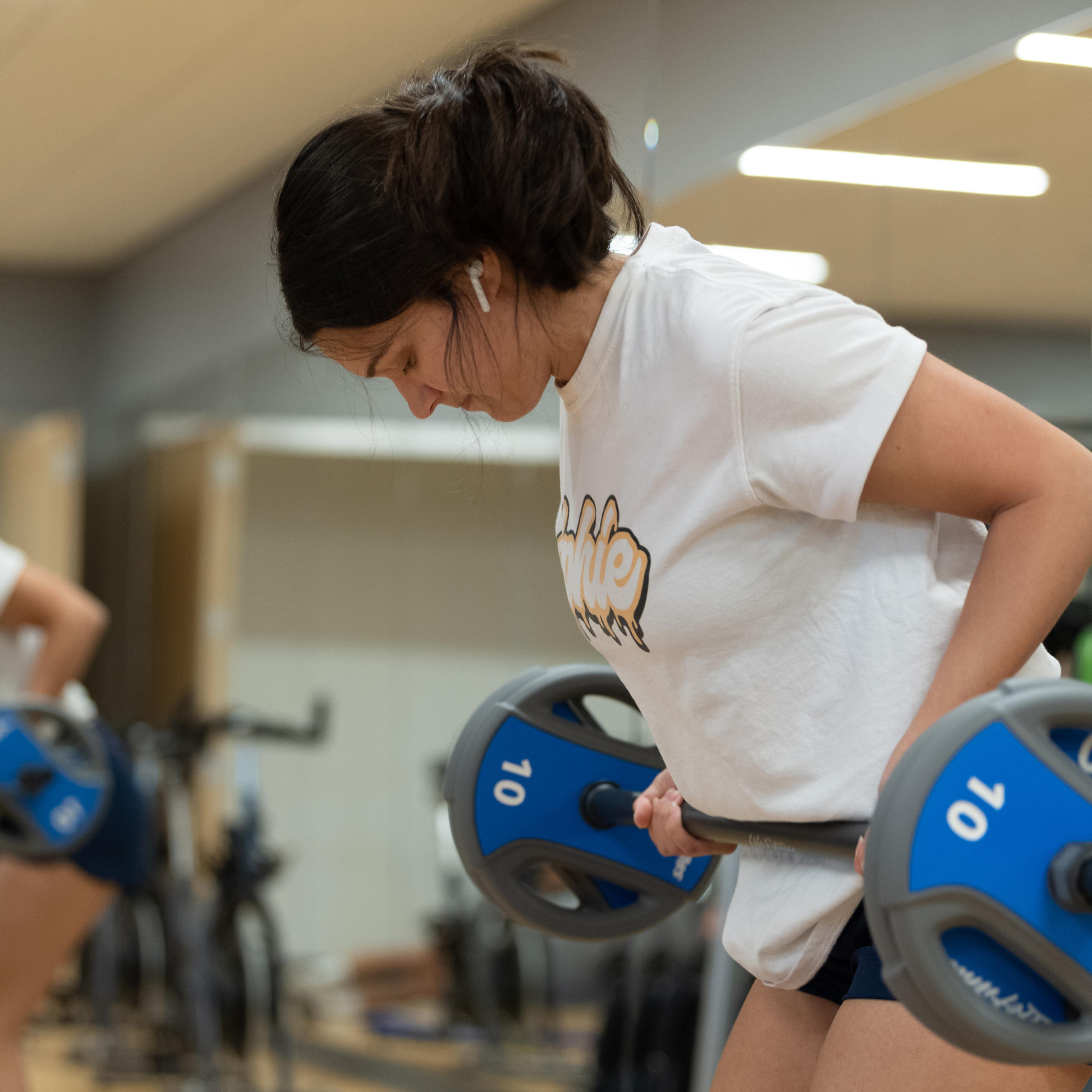 Student lifts weights in the UCC fitness center.