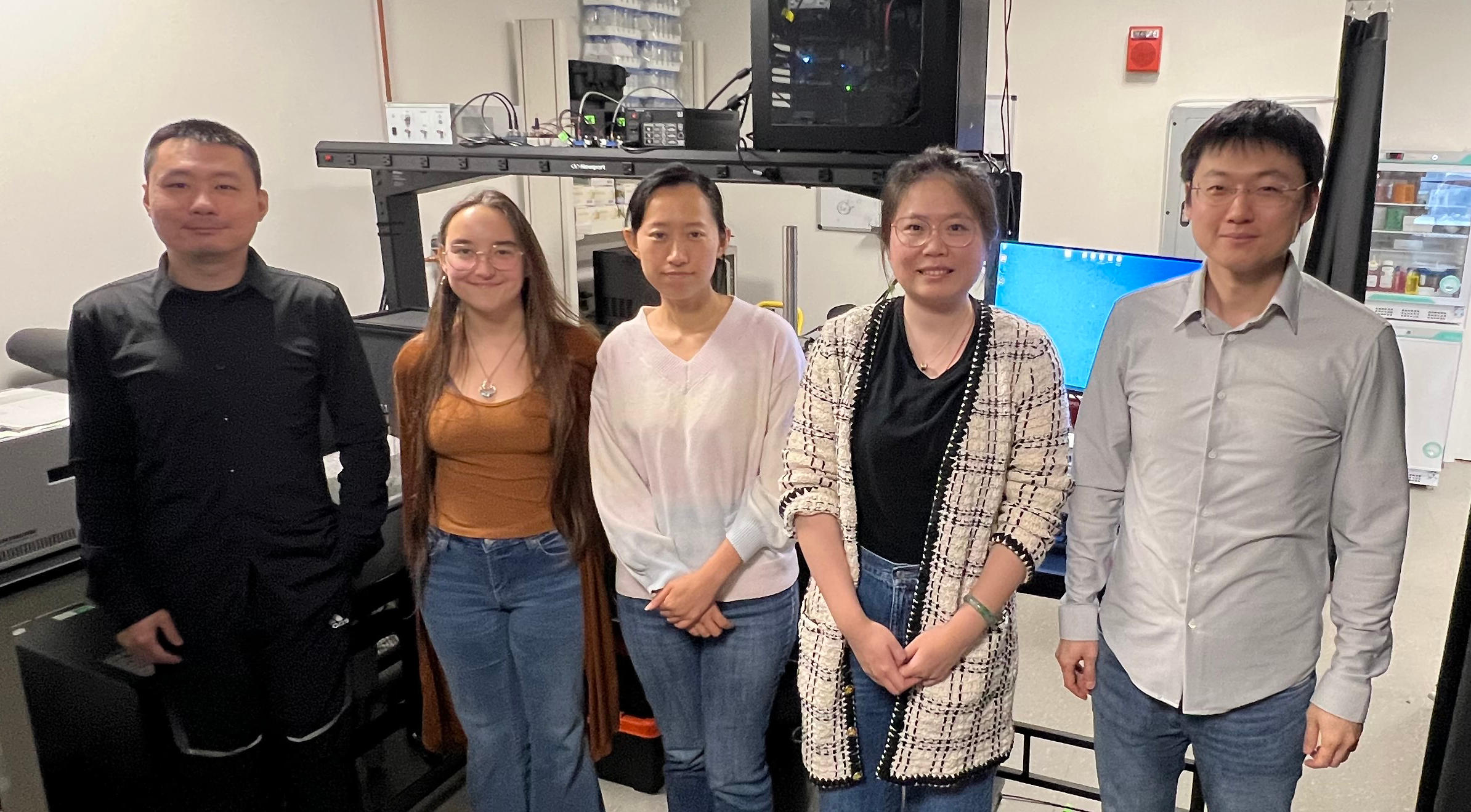 Wang and four of his group members in their laboratory. From left to right: Tianqi Fang, Aleese Mukhamedjanova, Huan Han, Jingyu Sun and Shang Wang