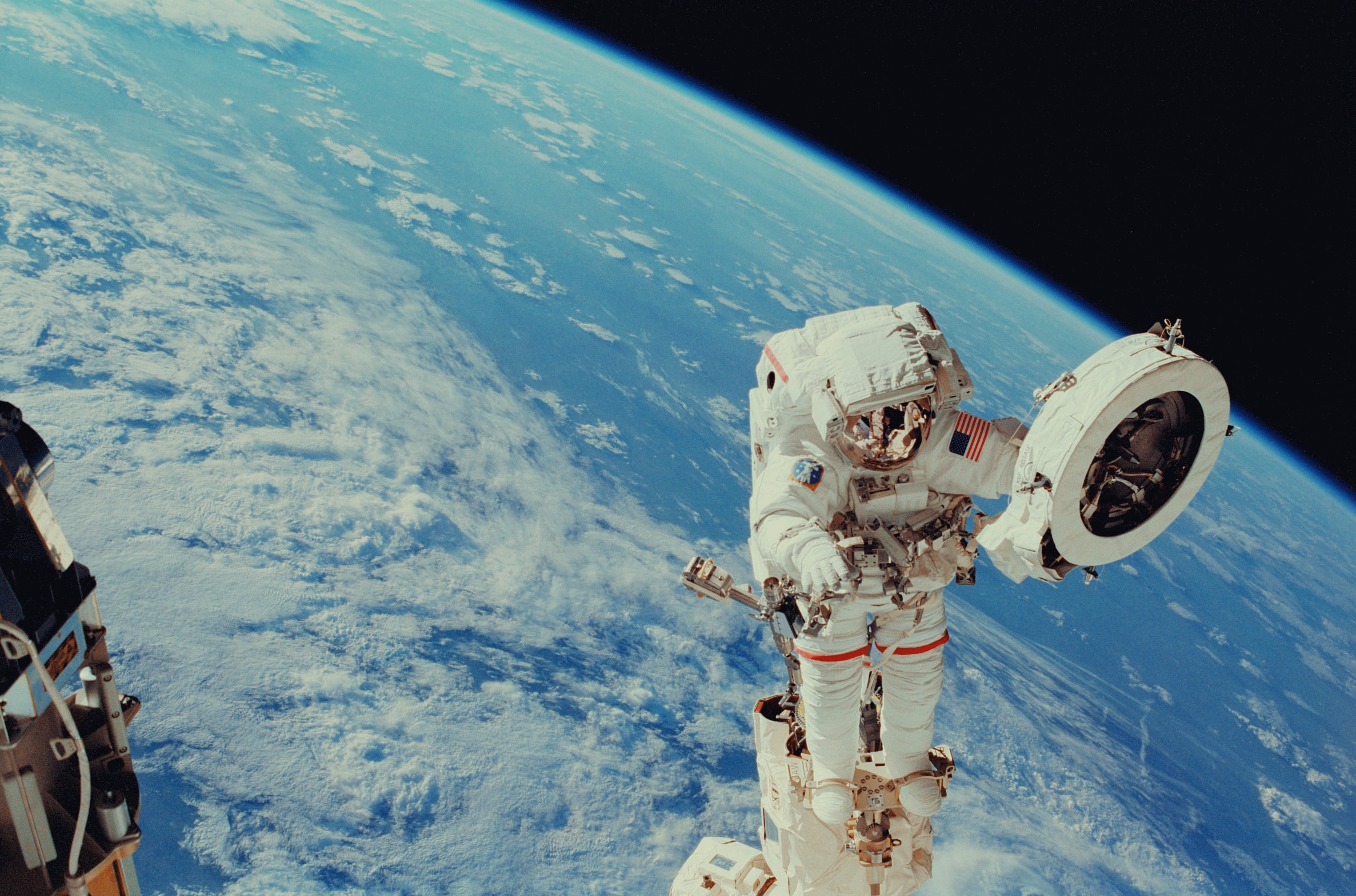 Astronaut floating in space with Earth behind him
