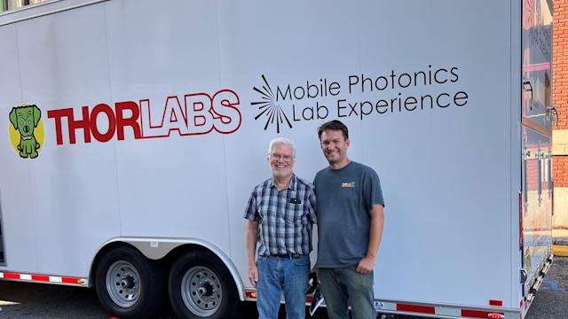Professor Ed Whittaker and Bill Warger ’03 in front of the Thorlabs Mobile Photonics Lab Experience