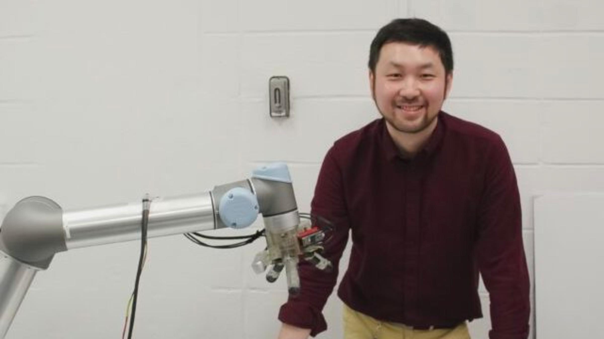 Long Wang with robotic hand