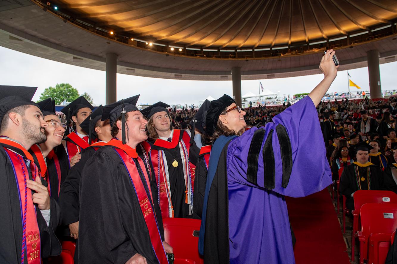 Sara Klein takes a selfie with several students.