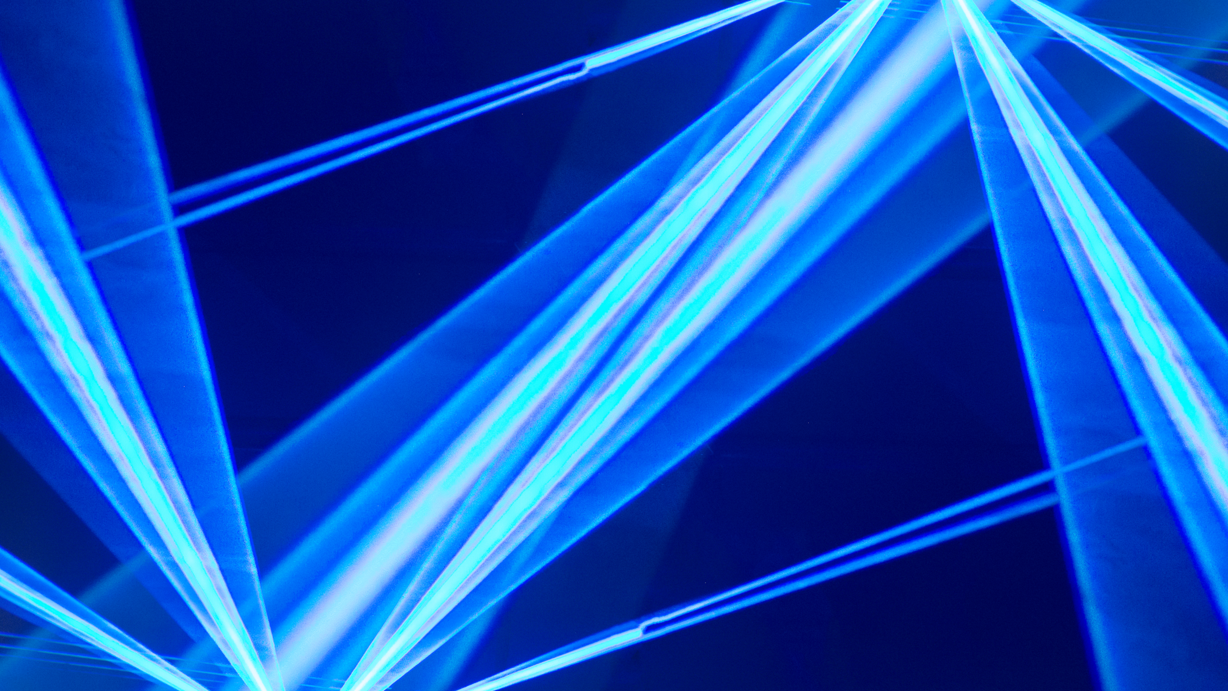Artistic, geometric representation of lasers pointing in blue color