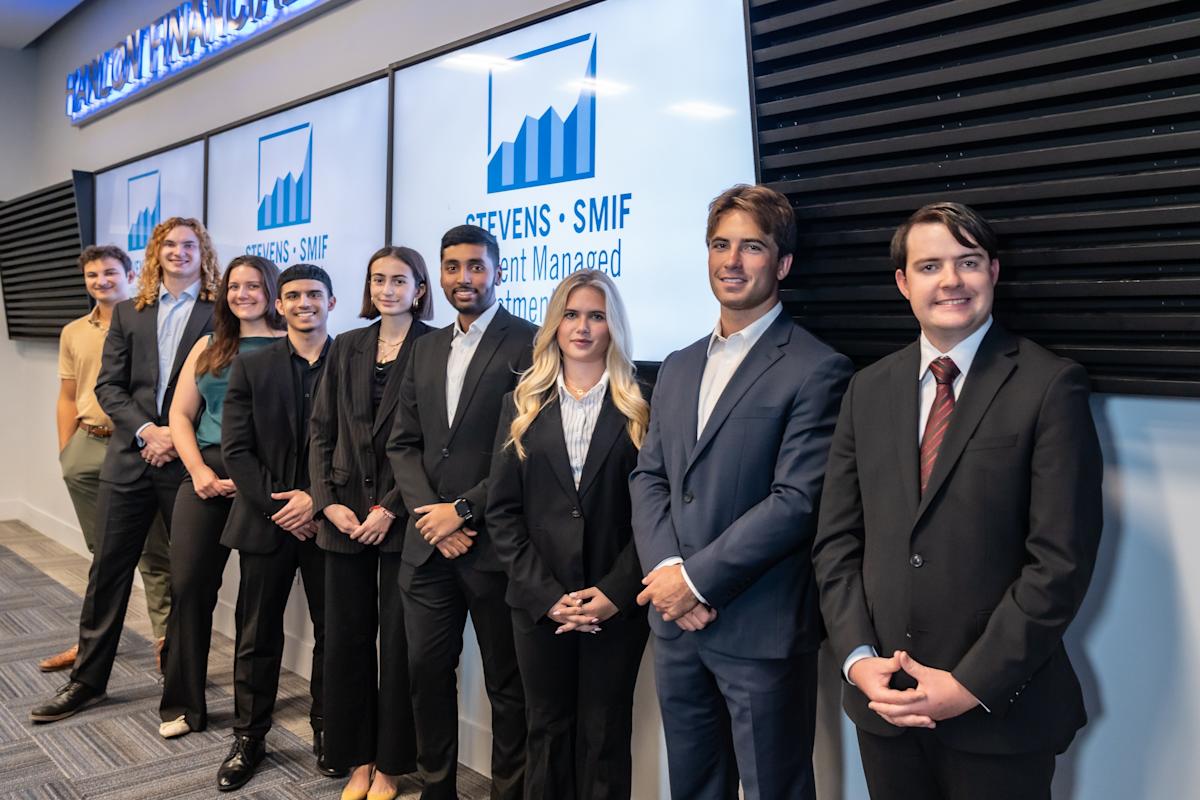 Group of SSMIF students gather for a group photo in business formal attire