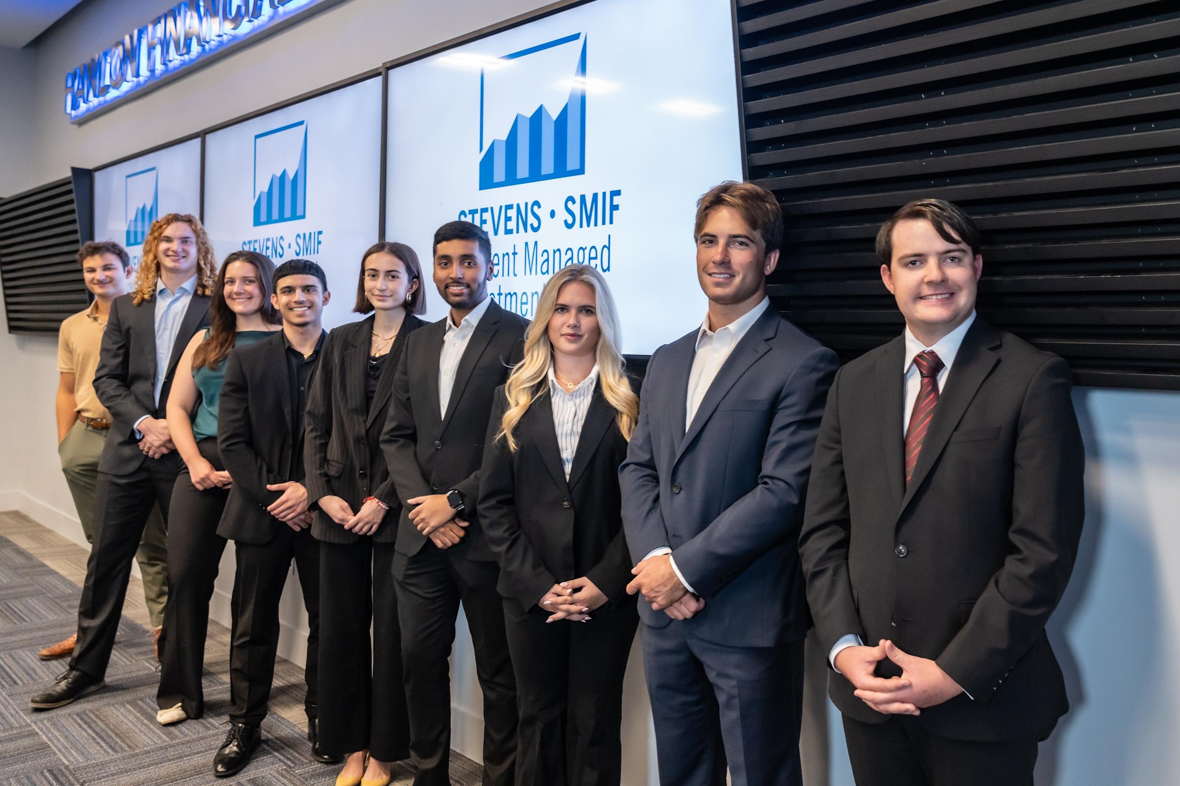 Group of SSMIF students gather for a group photo in business formal attire