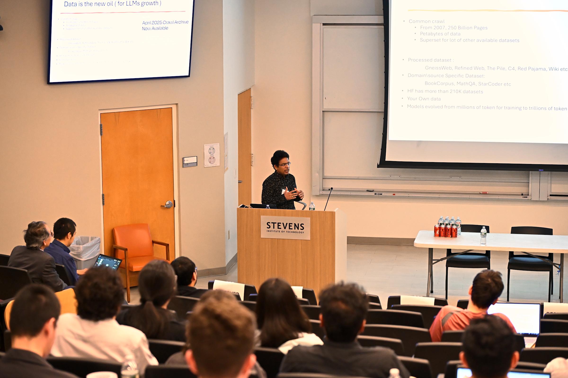 People sit in an auditorium watching a presentation.