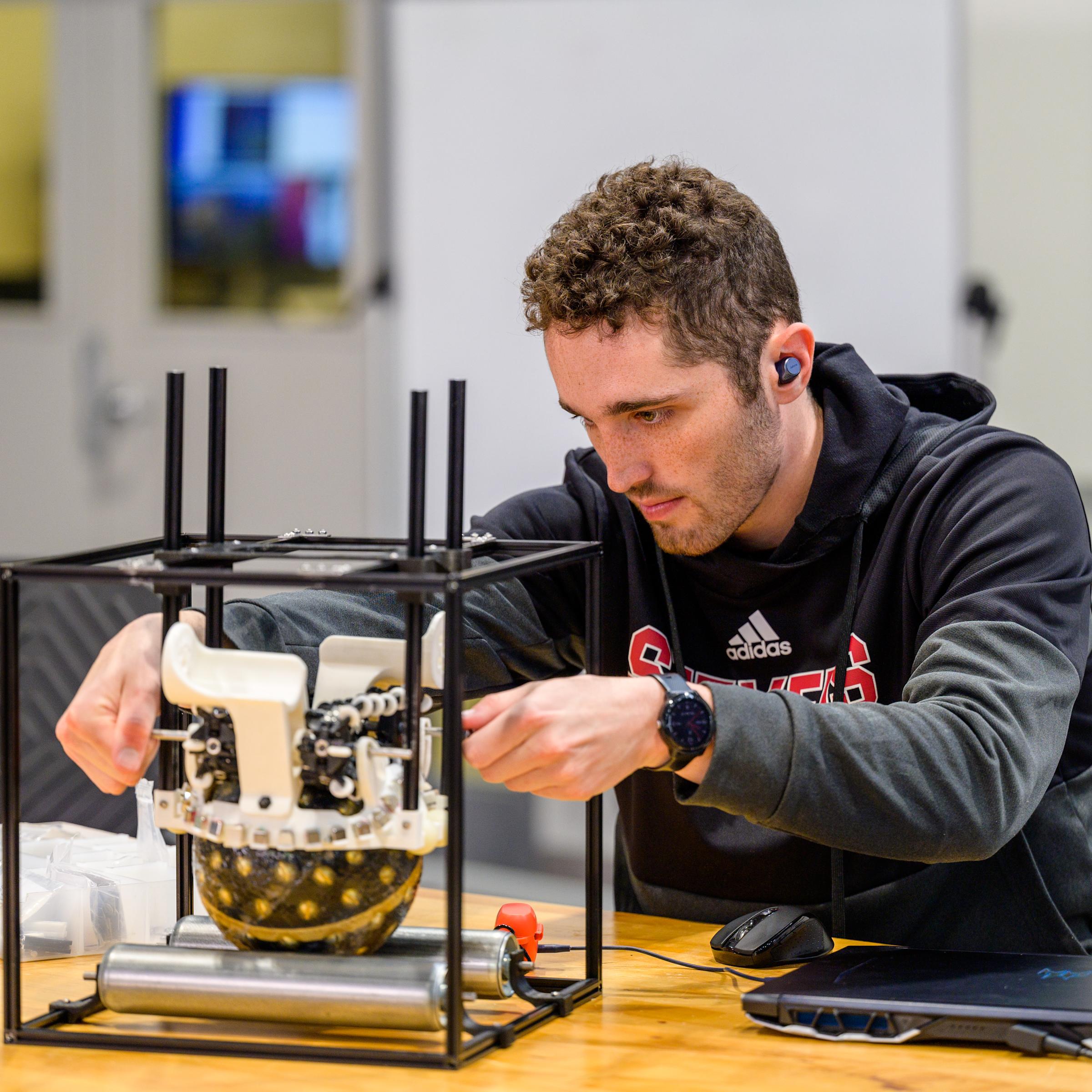 student working on robotics project