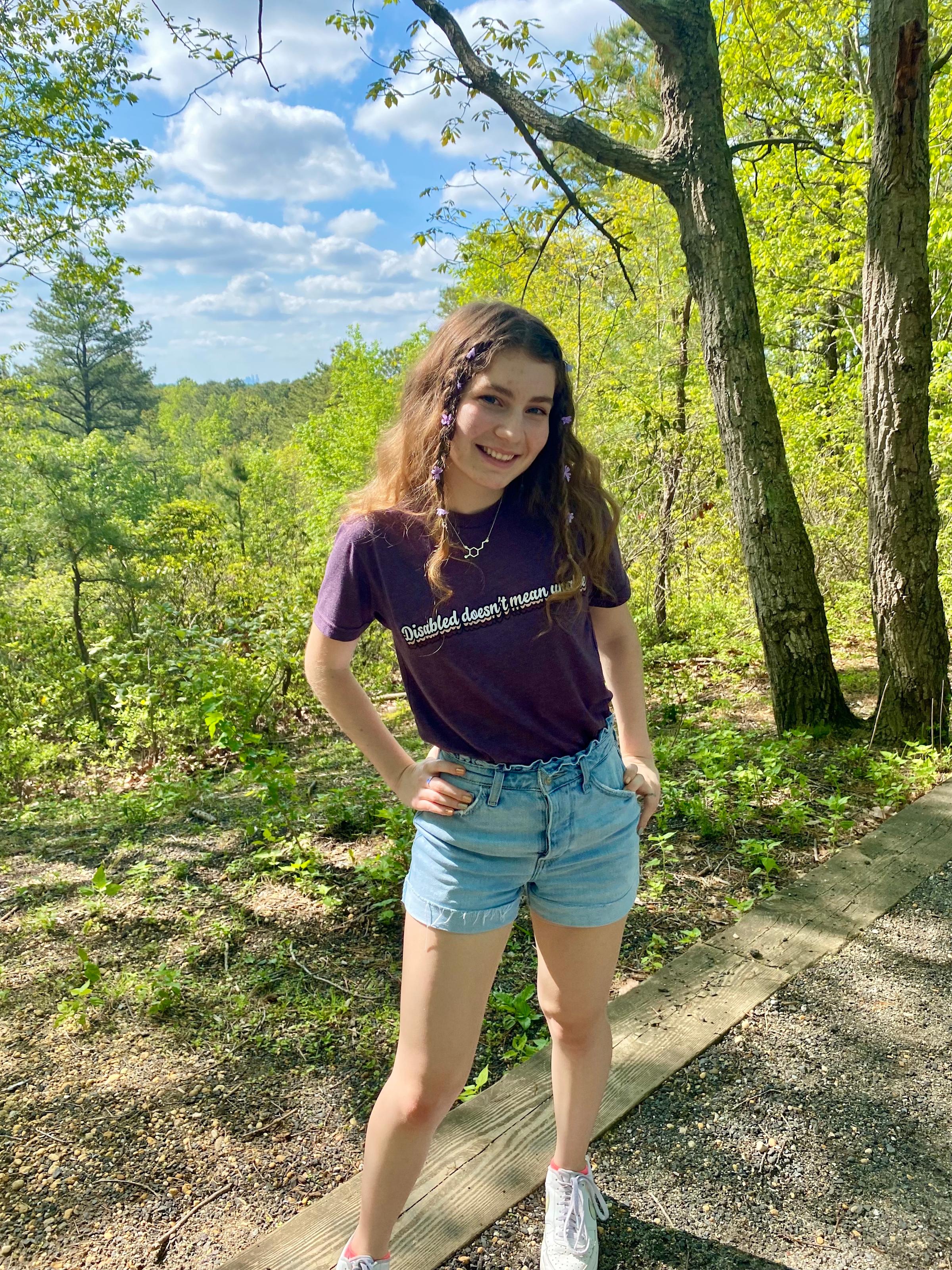 Photo of Jenna Giesecke '25 standing outside in front of trees