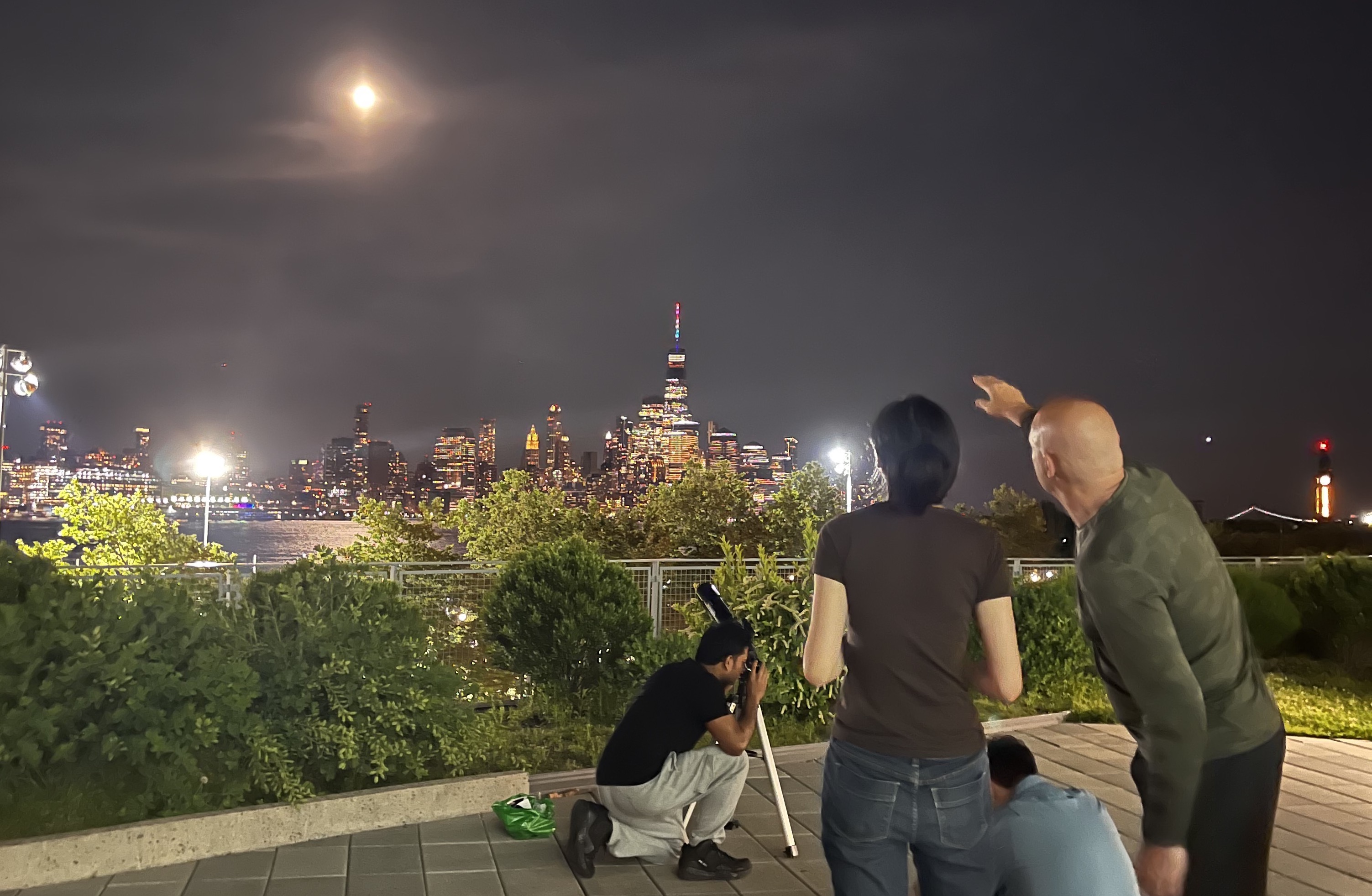 Ting Lu with telescope overlooking Manhattan
