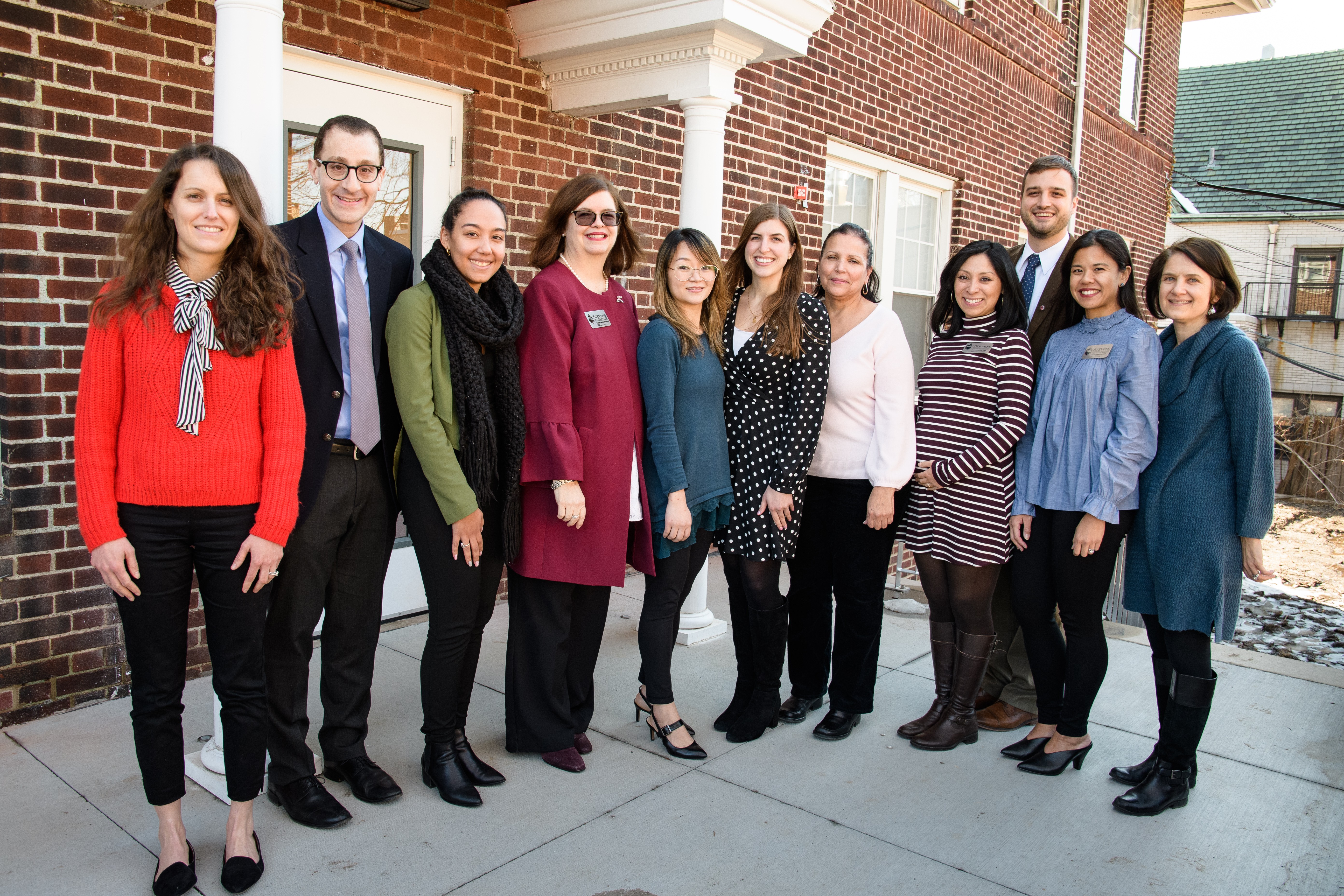 Members of the wellness team pose outside in front of the Student Wellness Center