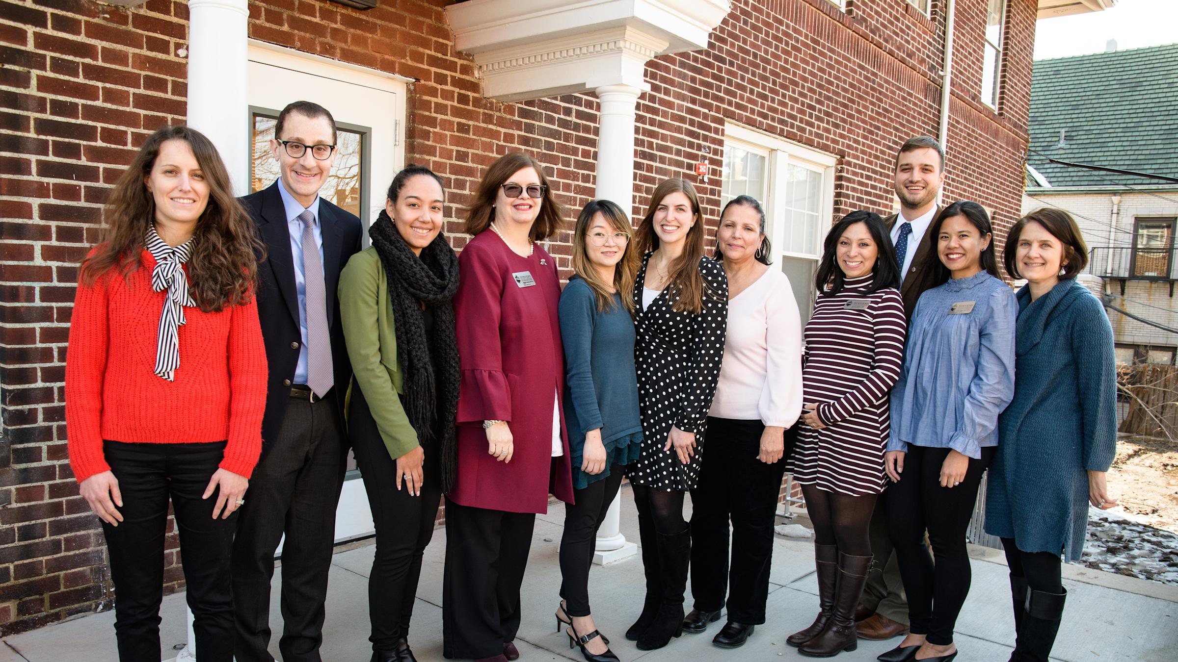Members of the wellness team pose outside in front of the Student Wellness Center