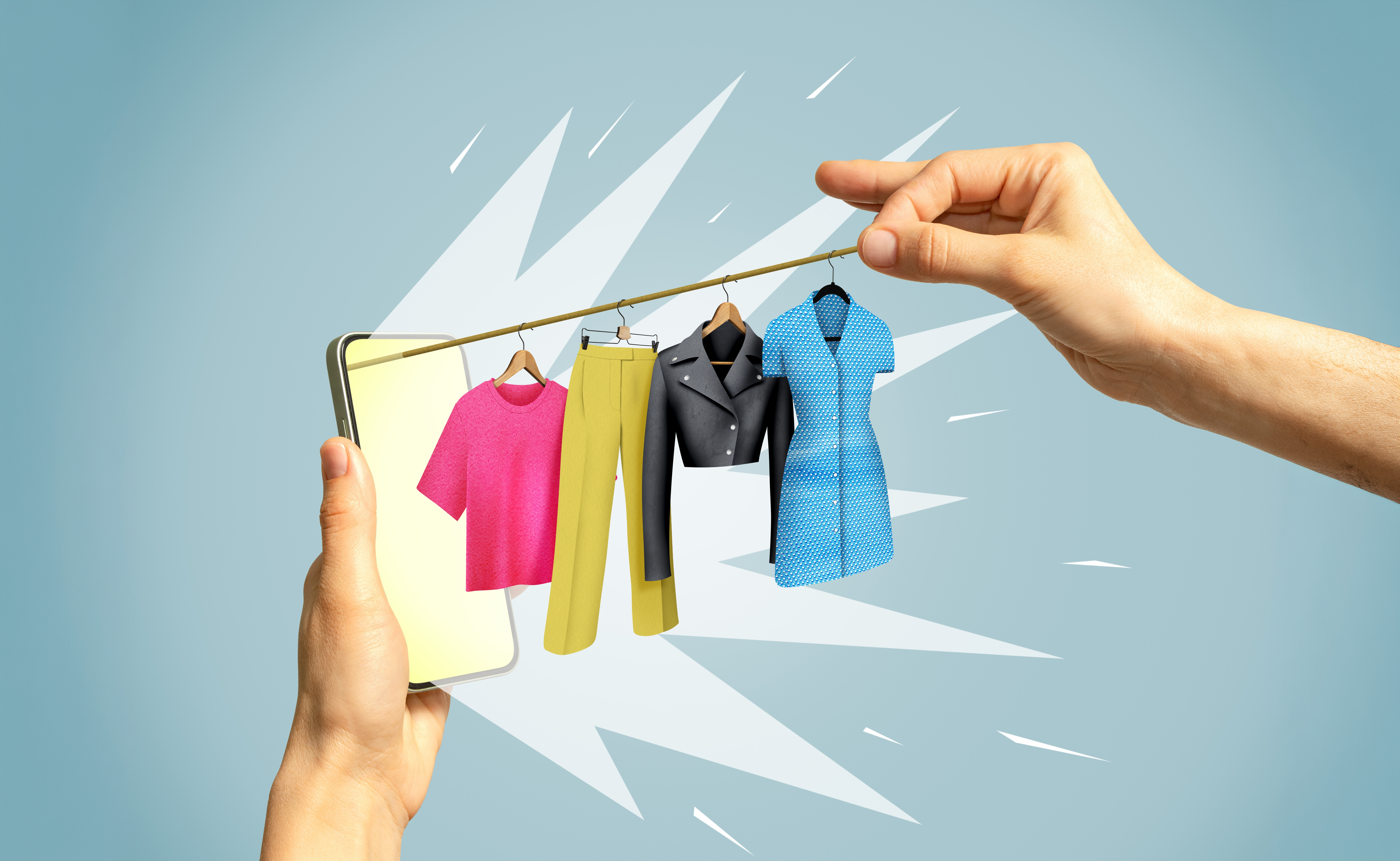 One hand holds up a phone while another pulls a string of different clothing items out of it.