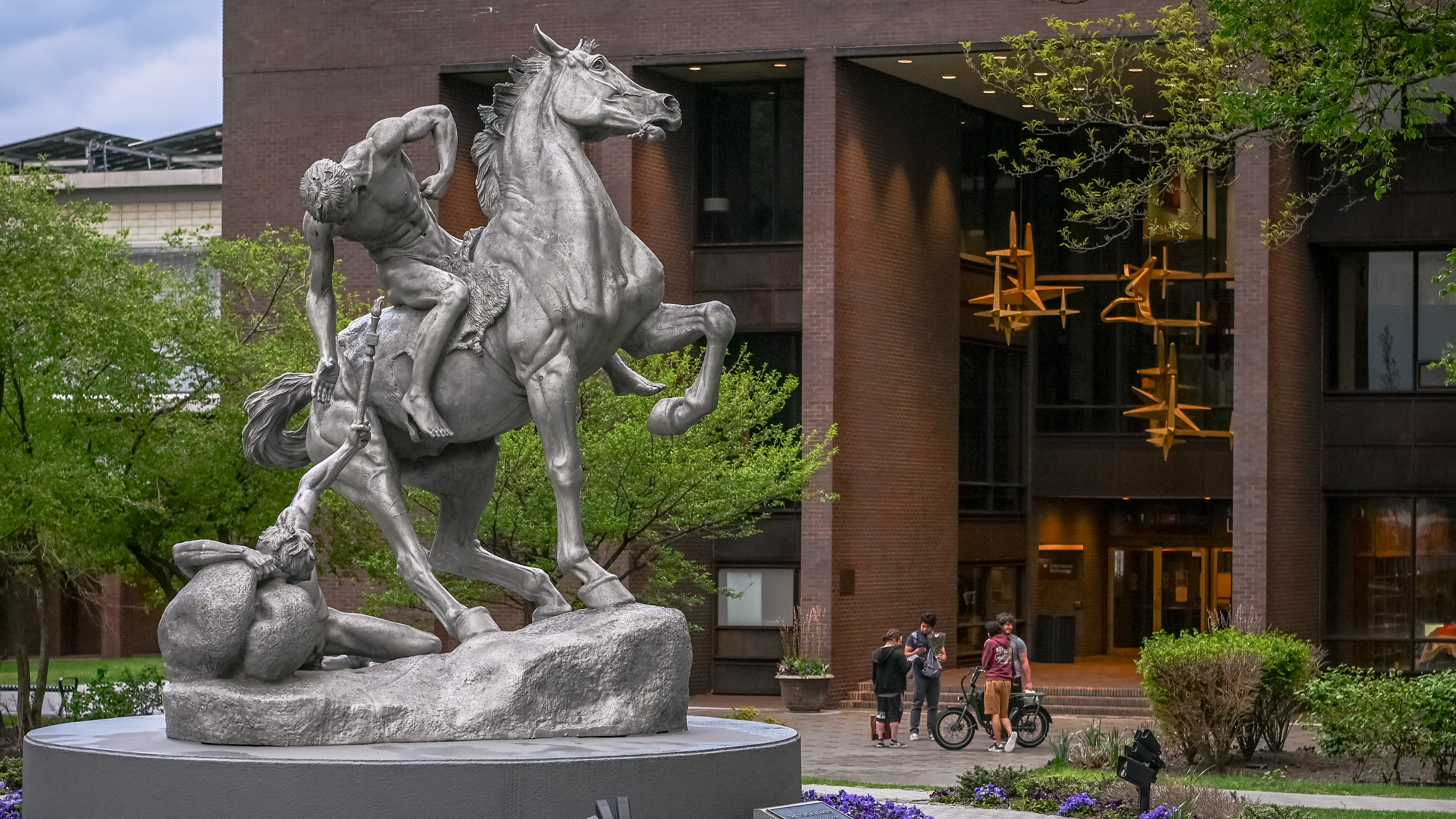 Torch Bearer sculpture on Stevens campus, depicting a man on horseback handing torch to another on ground.