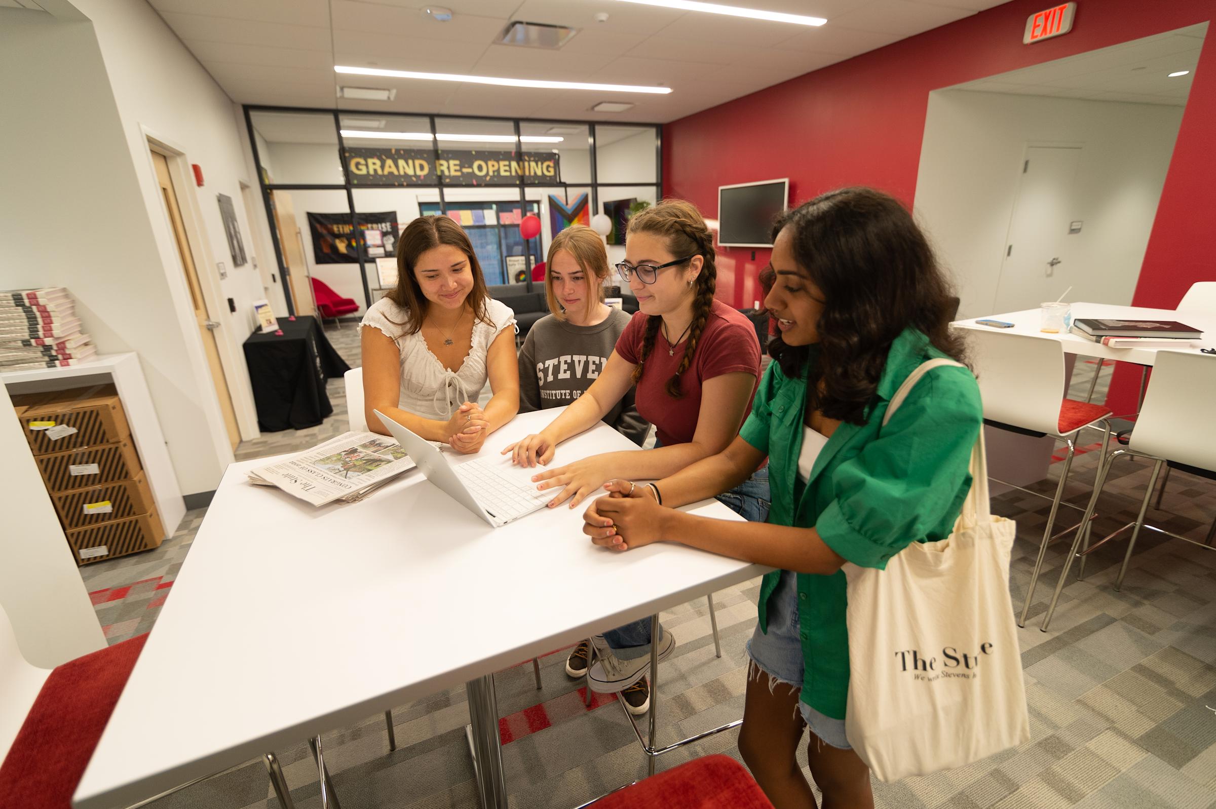 Four students gather in the Semcer Student Commons