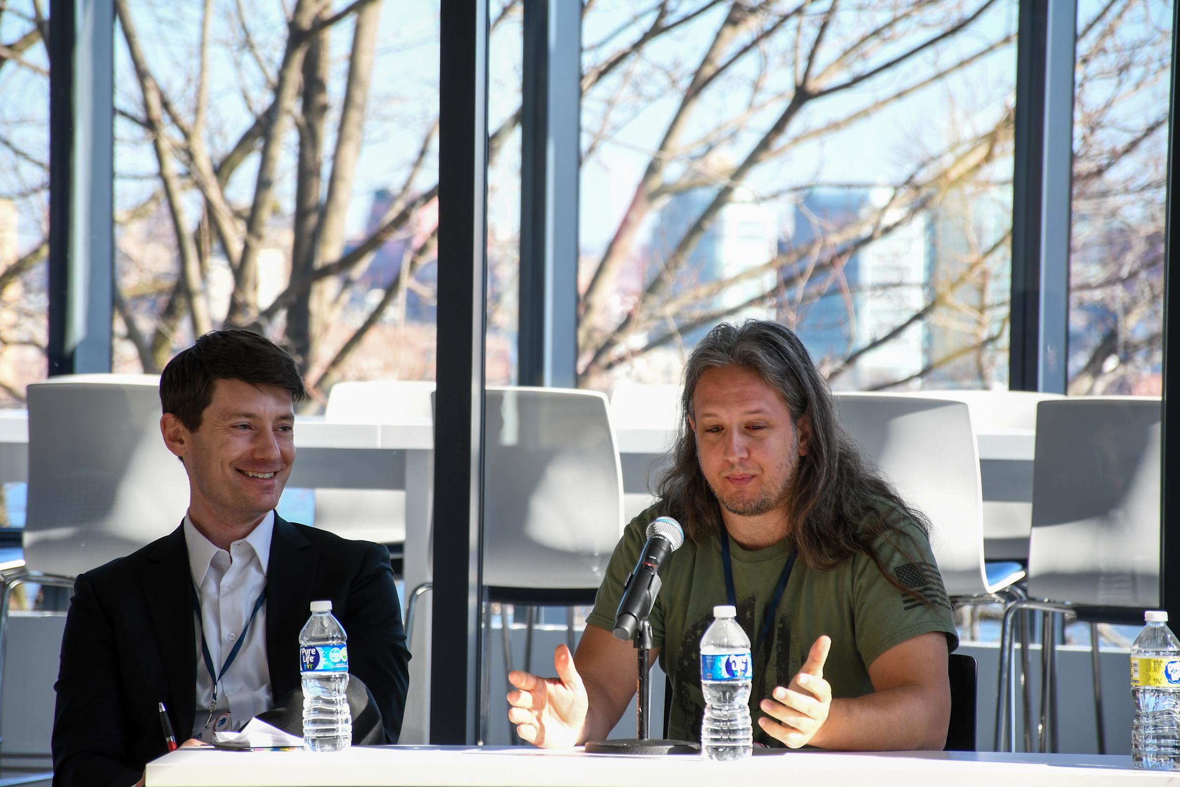 Two speakers smiling during CSER 2023.