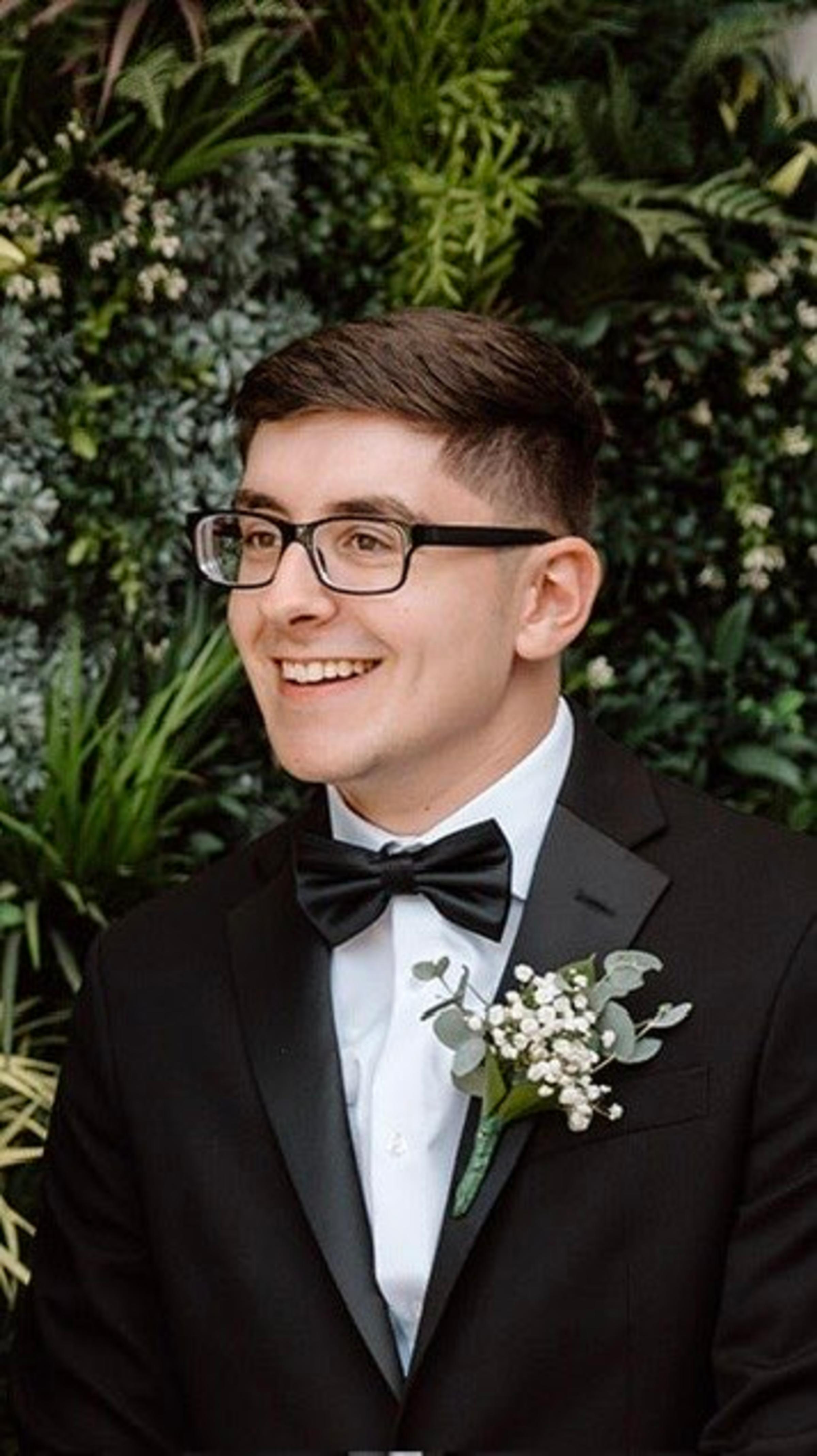 A headshot of a man in a tux