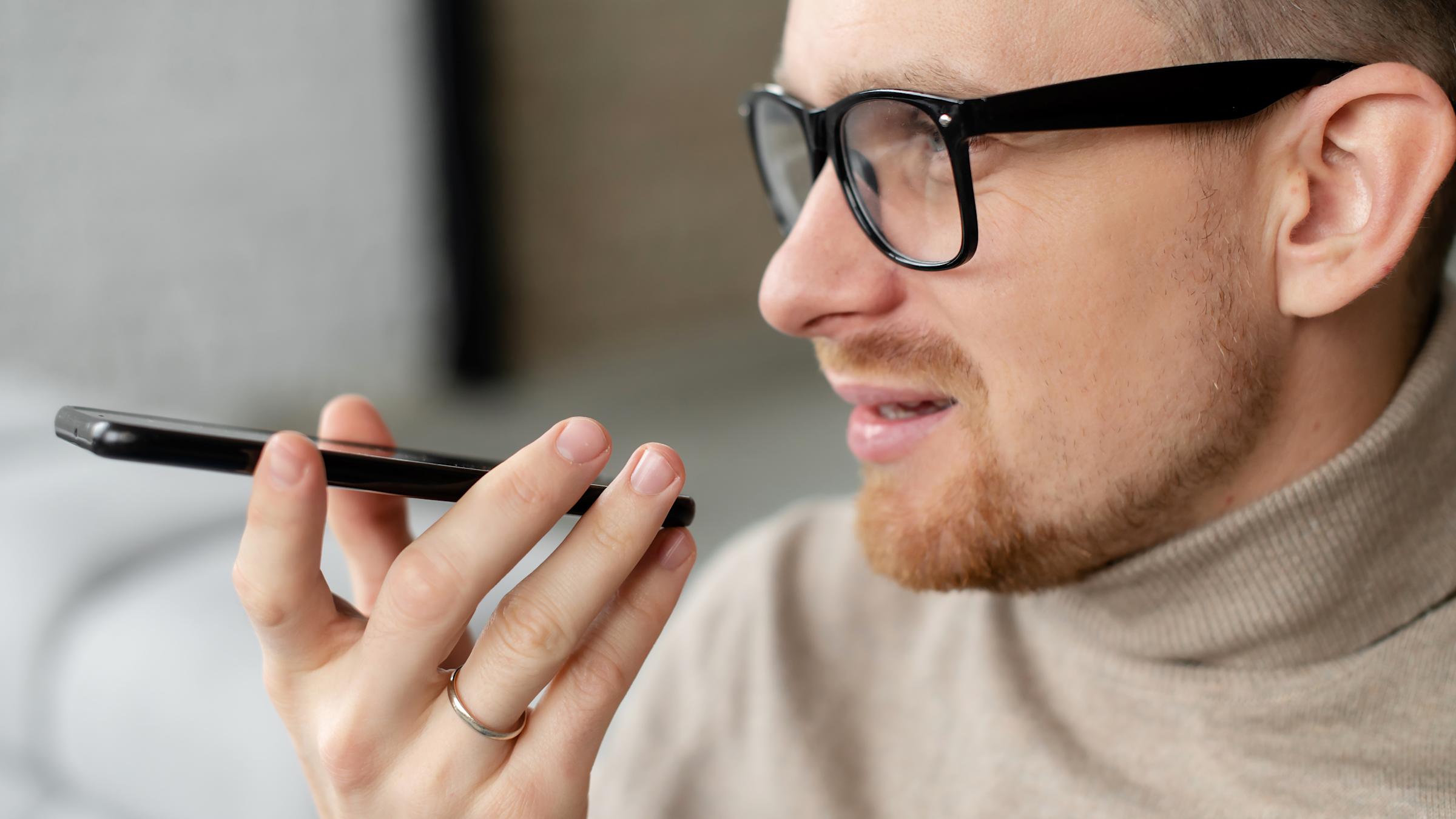 Man talking out loud into iphone