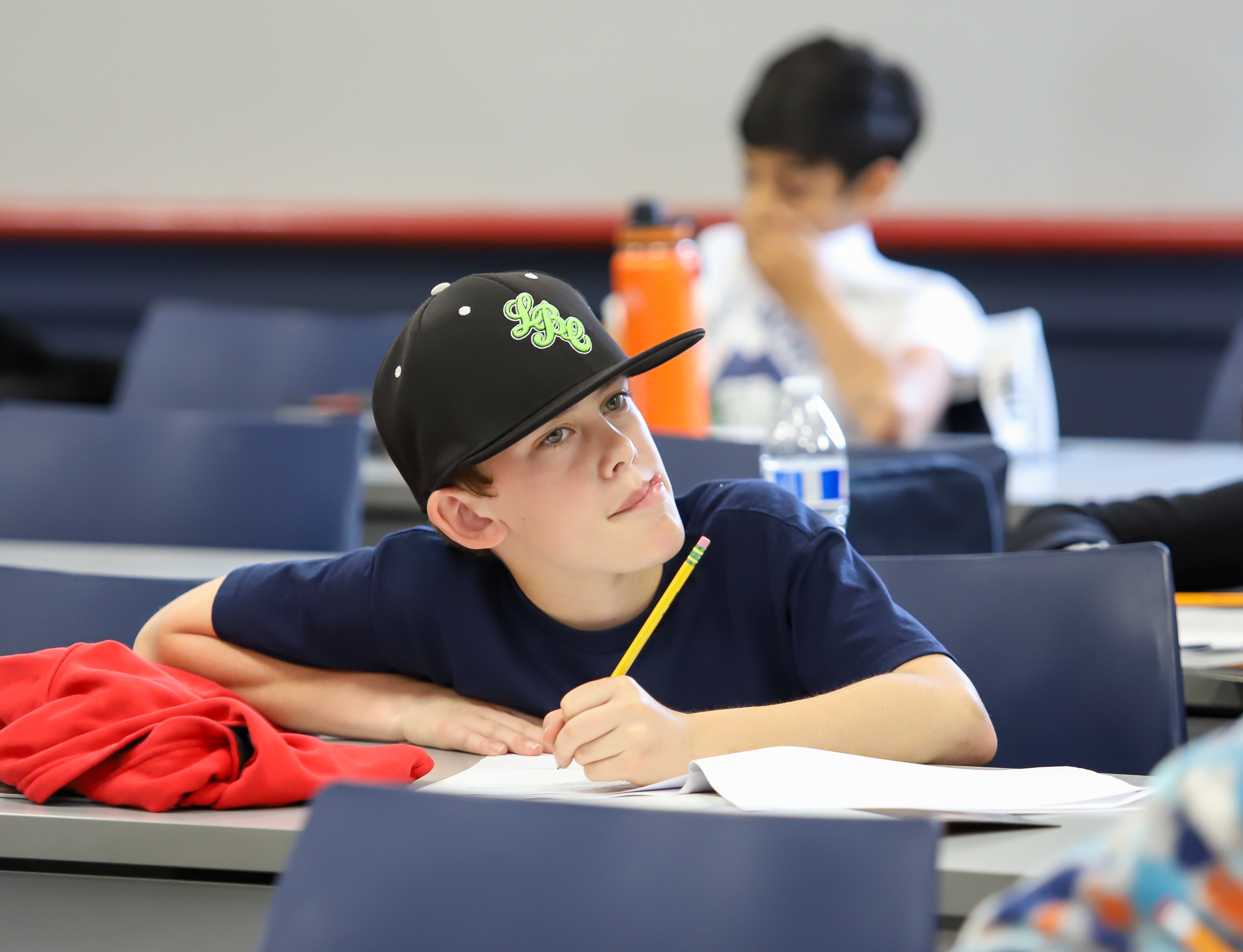 student pondering while taking test at the 2023 Math Olympiad