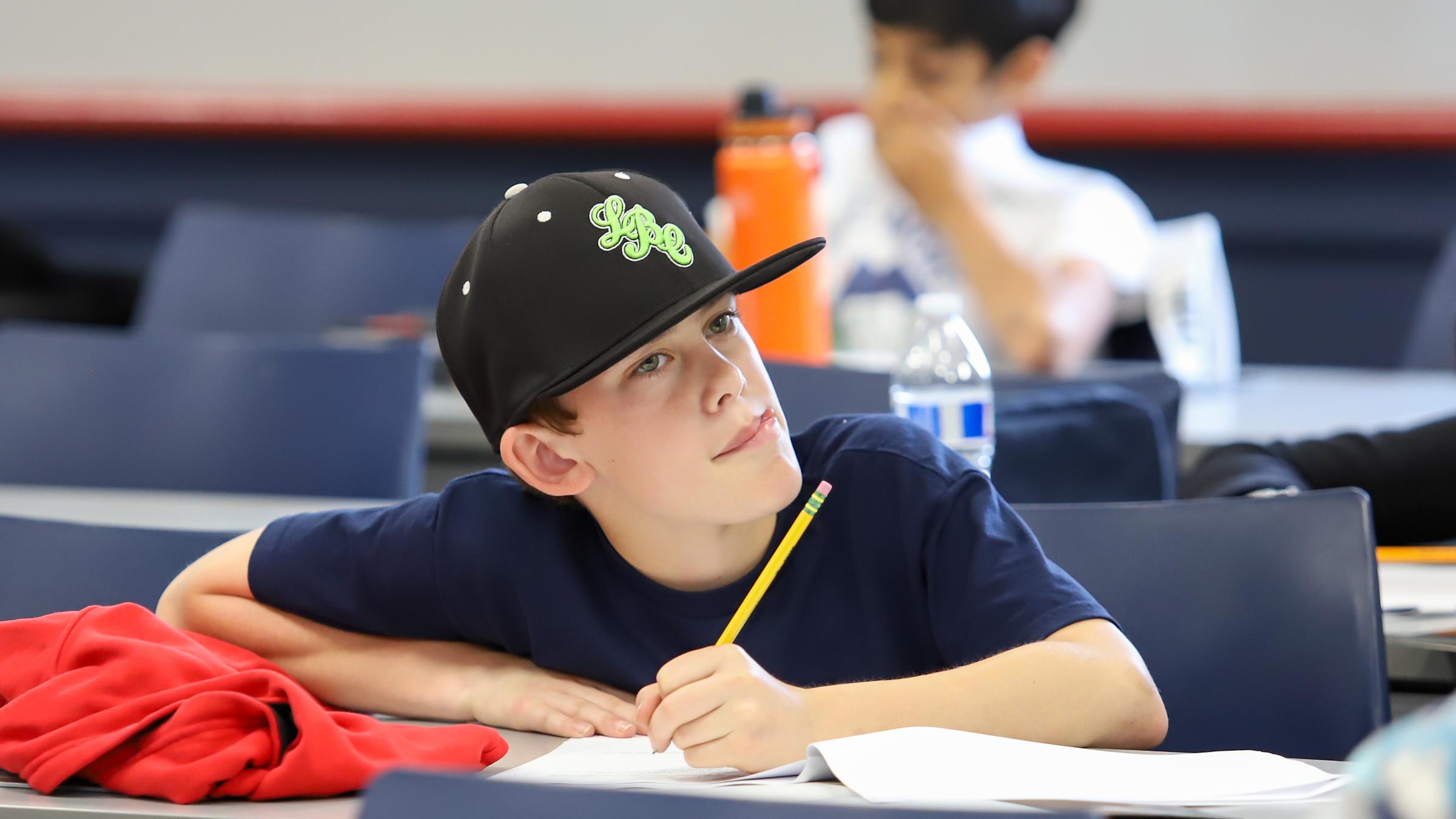 student pondering while taking test at the 2023 Math Olympiad