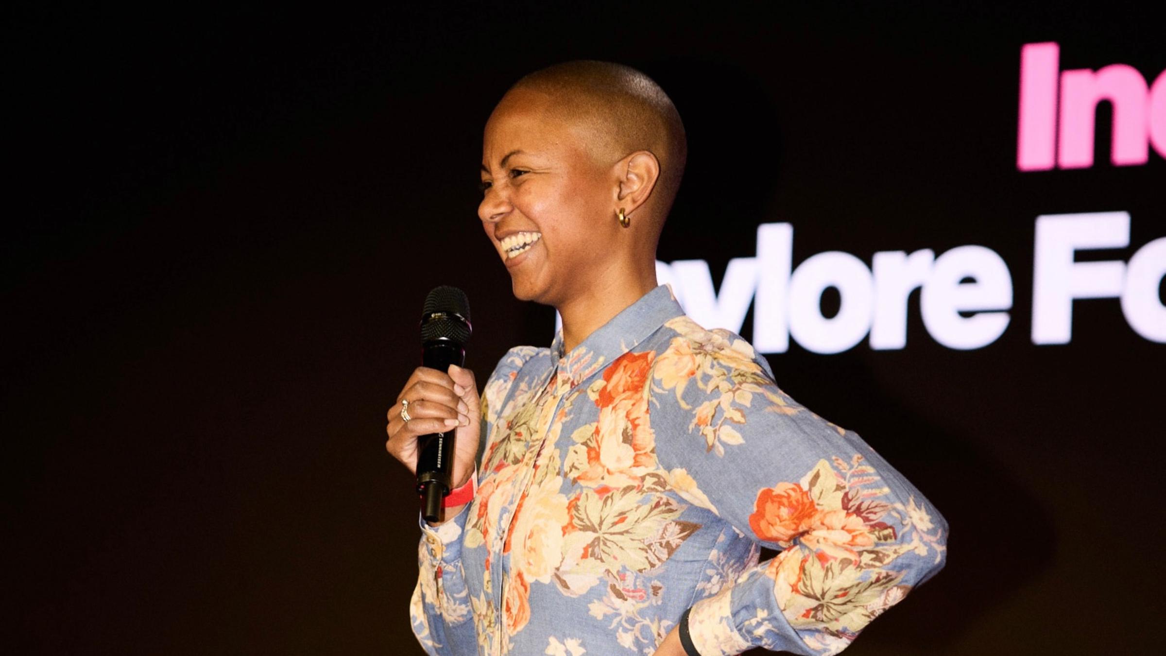 Taylore Fowler ’14 uses a microphone on stage