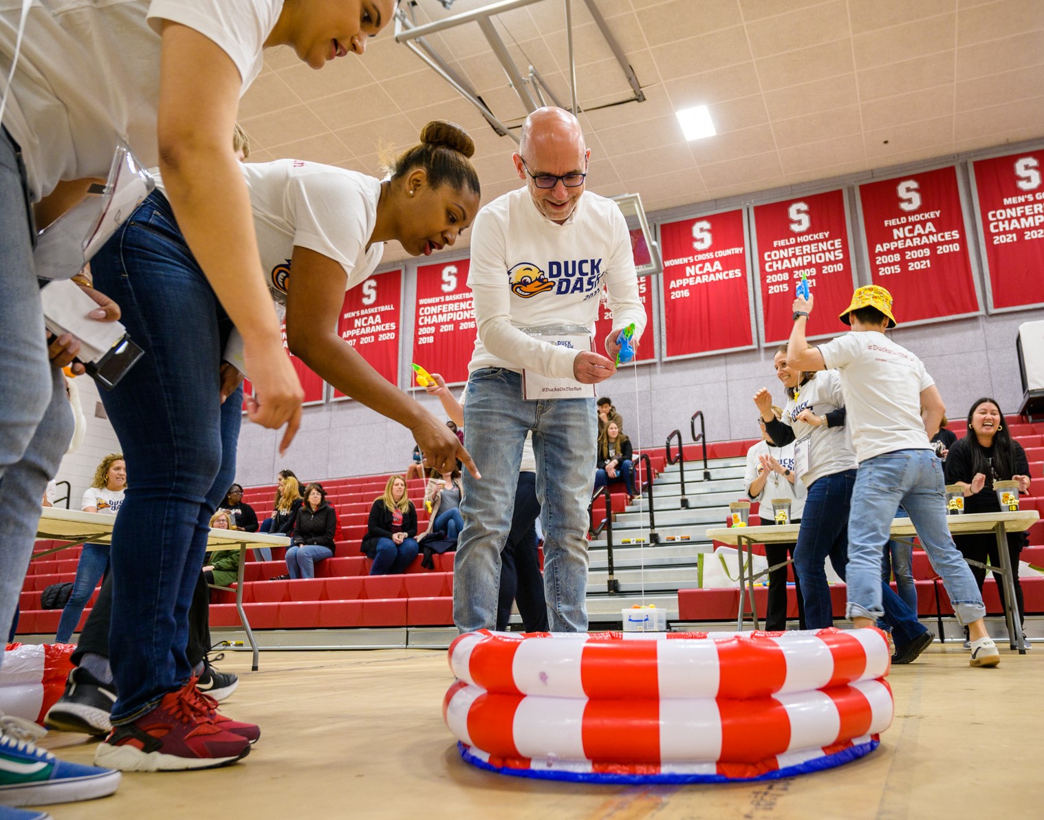 Duck dashers play a fishing game in Canavan Arena