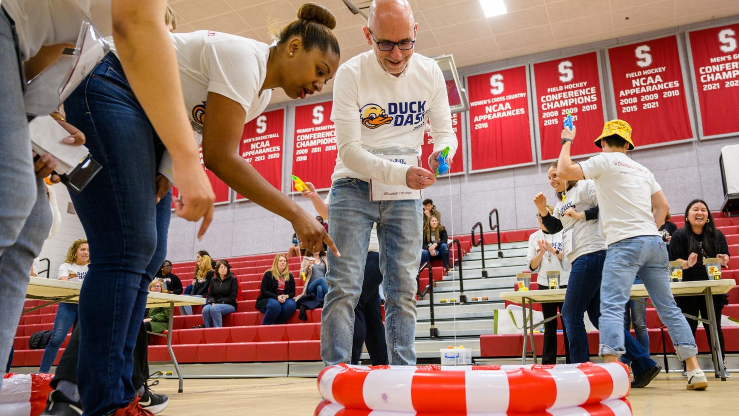 Duck dashers play a fishing game in Canavan Arena